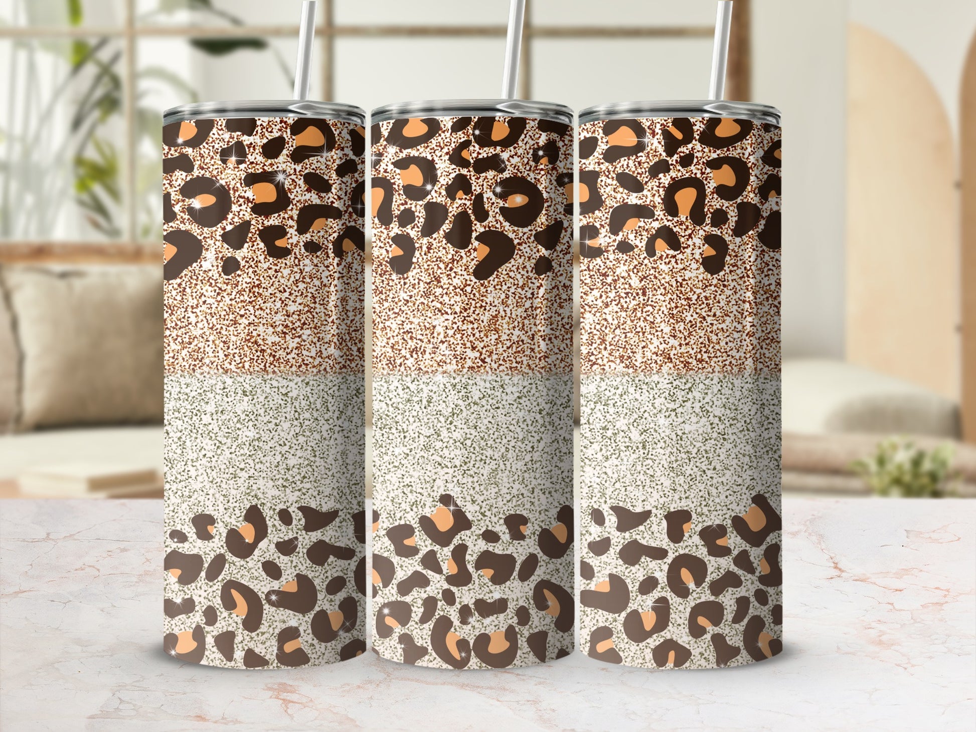Three tumblers with leopard print and glitter designs stand in a row.