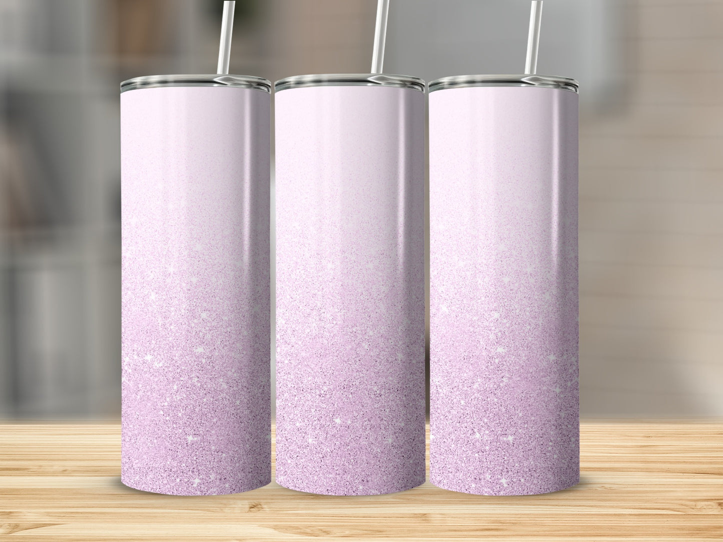 Three tall, tapered tumblers with a pink glitter gradient and white straws.