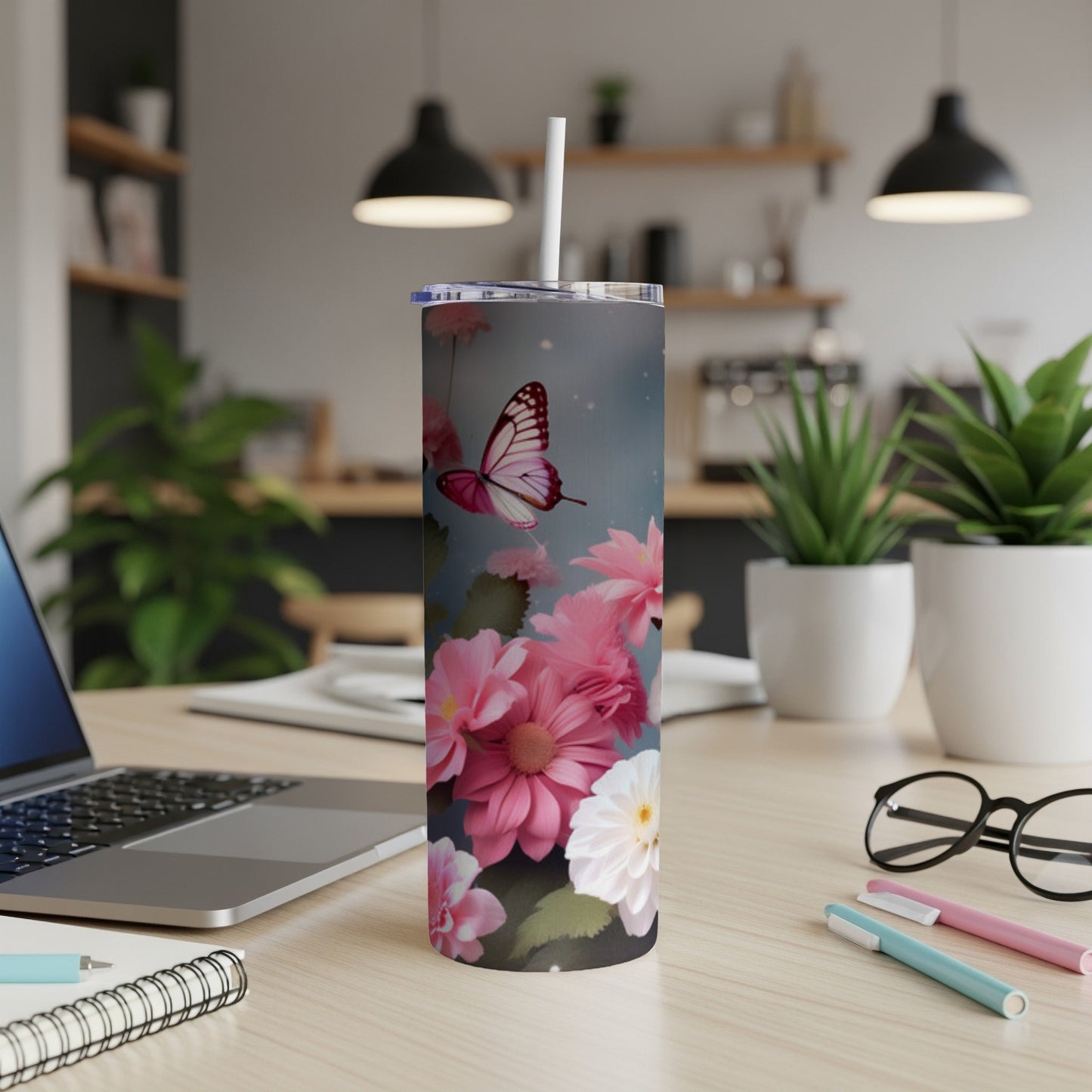 Pink butterfly and flowers on a white tumbler with a straw.