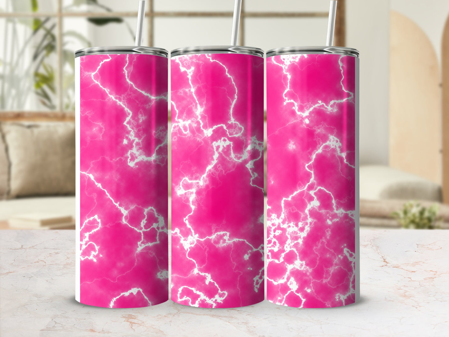 Three pink marble pattern tumblers with straws on a marble surface.