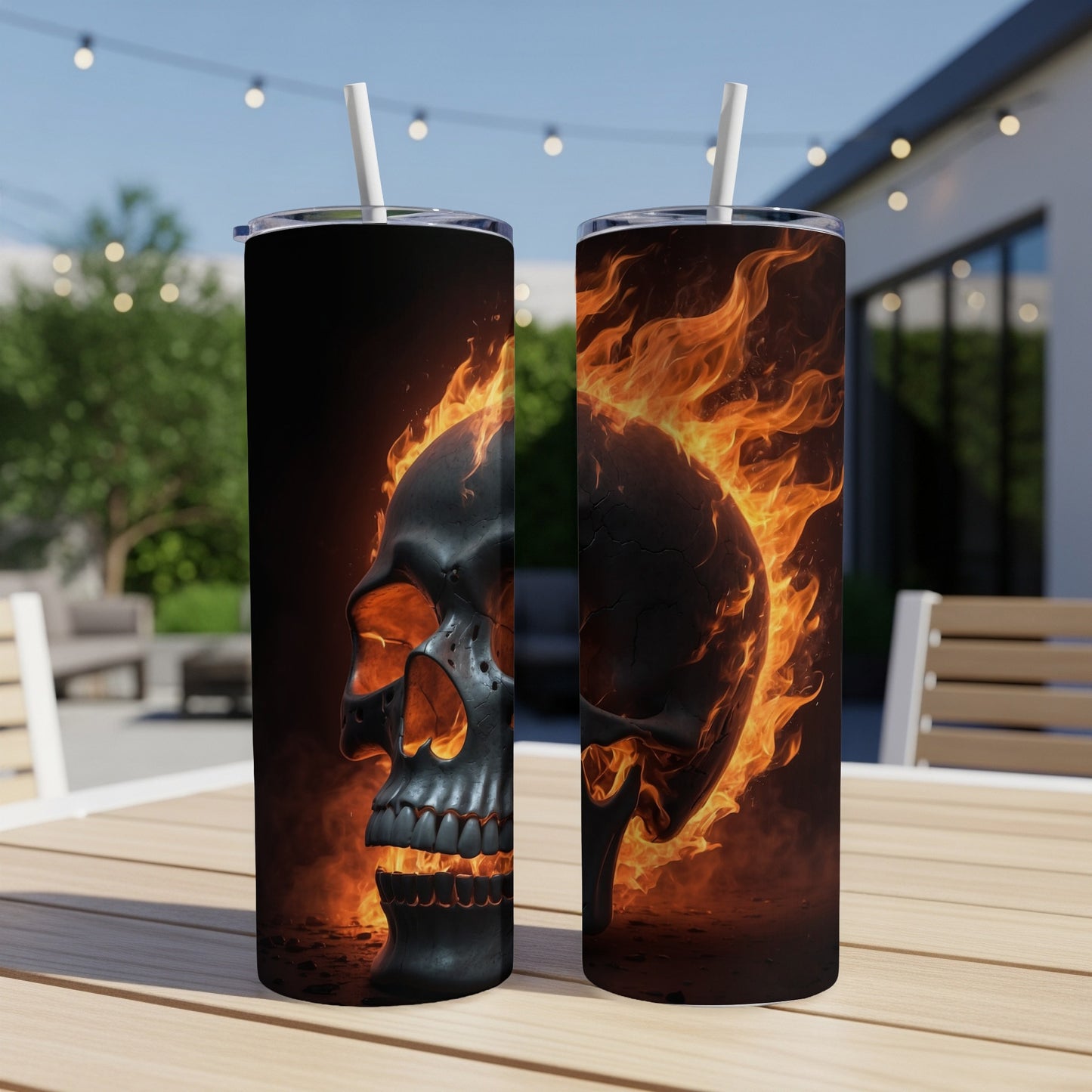 Two tumblers with a flaming skull design sit on a wooden table.