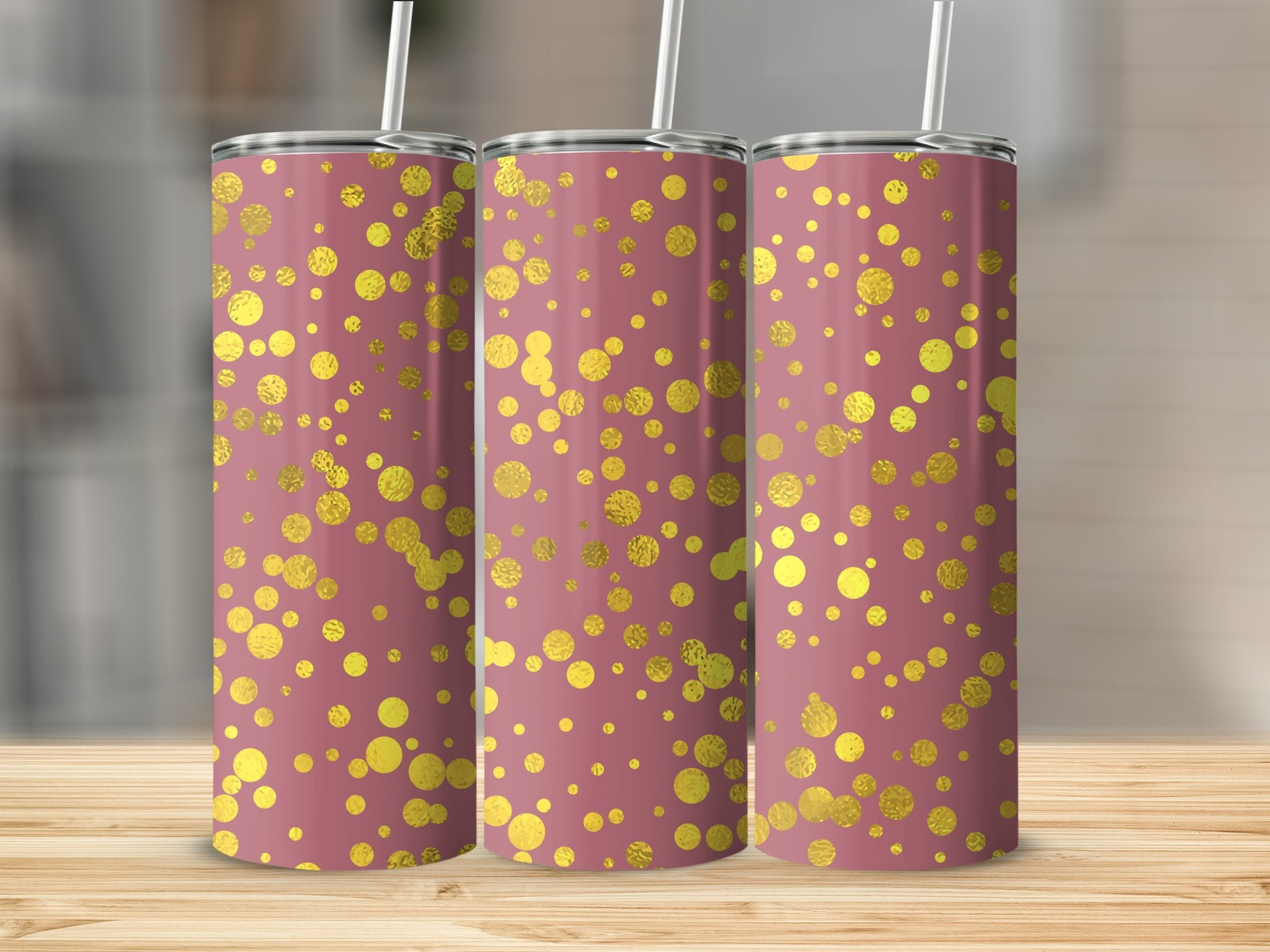 Three pink tumblers with a scattered gold polka dot pattern and white straws.