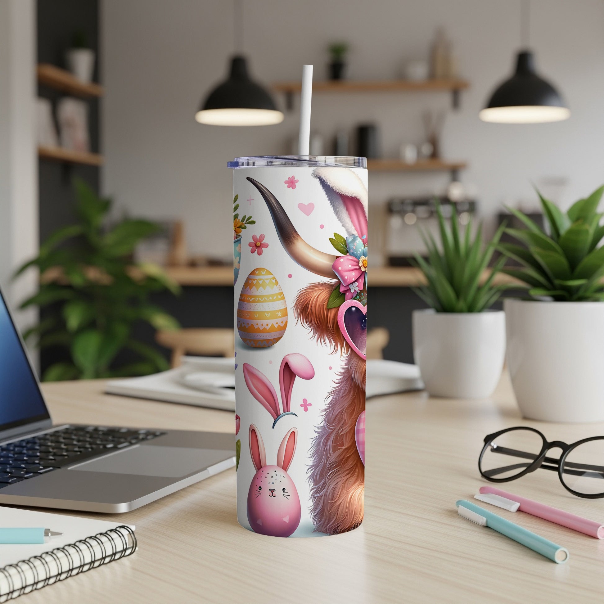 Highland cow with Easter graphics on a white tumbler.