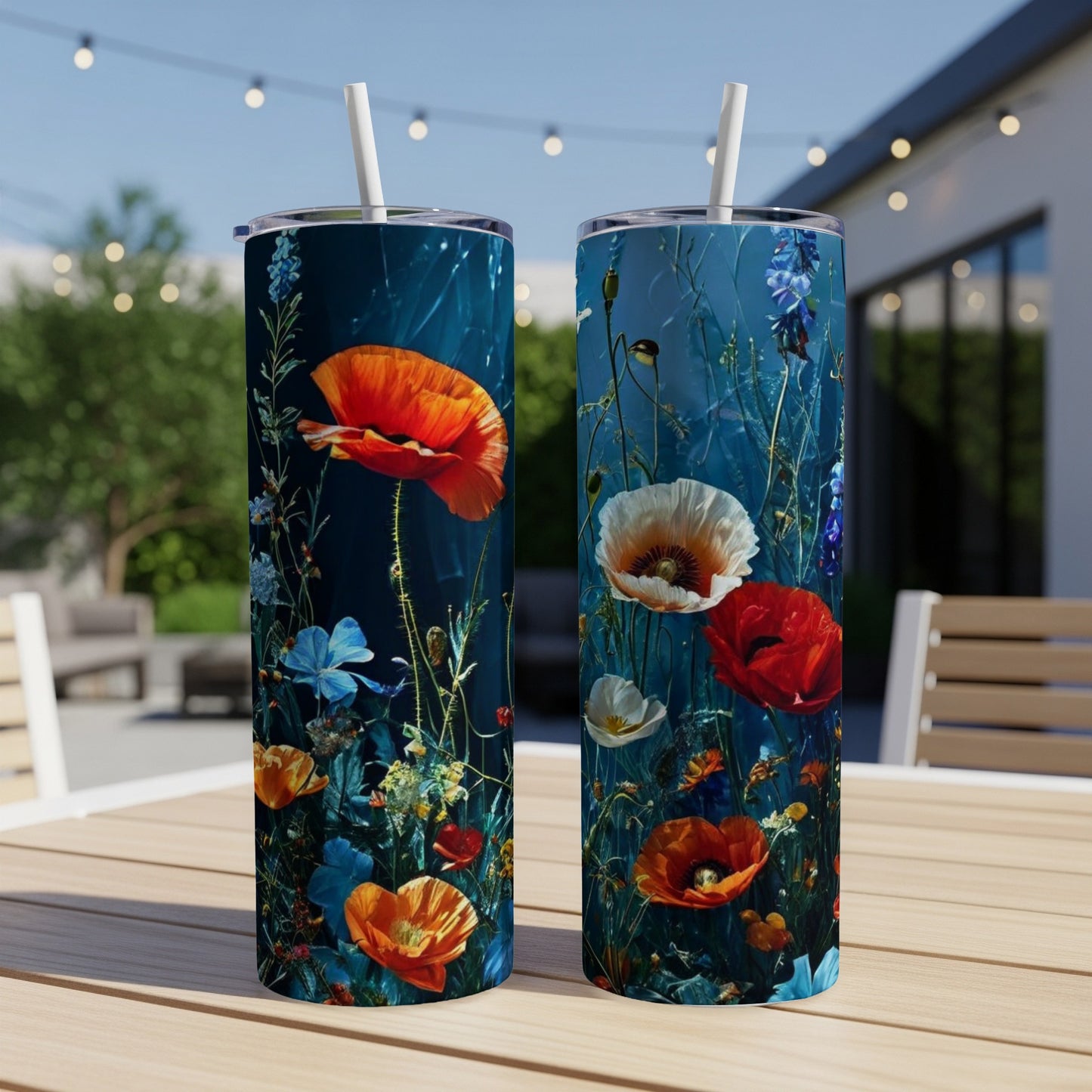 Two tall tumblers with vibrant poppy and floral designs on a wooden table.