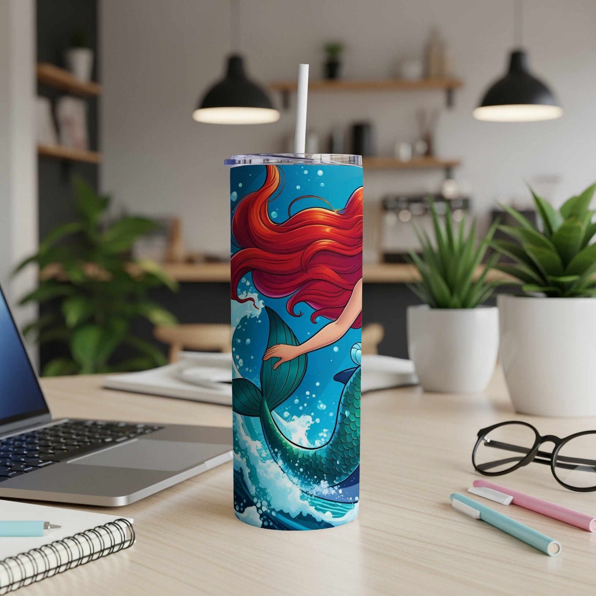 Mermaid's tail and flowing red hair on a vibrant blue, ocean wave tumbler.
