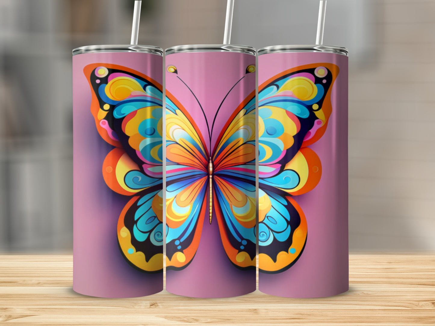 Three tumblers with colorful butterfly designs on a pink background.