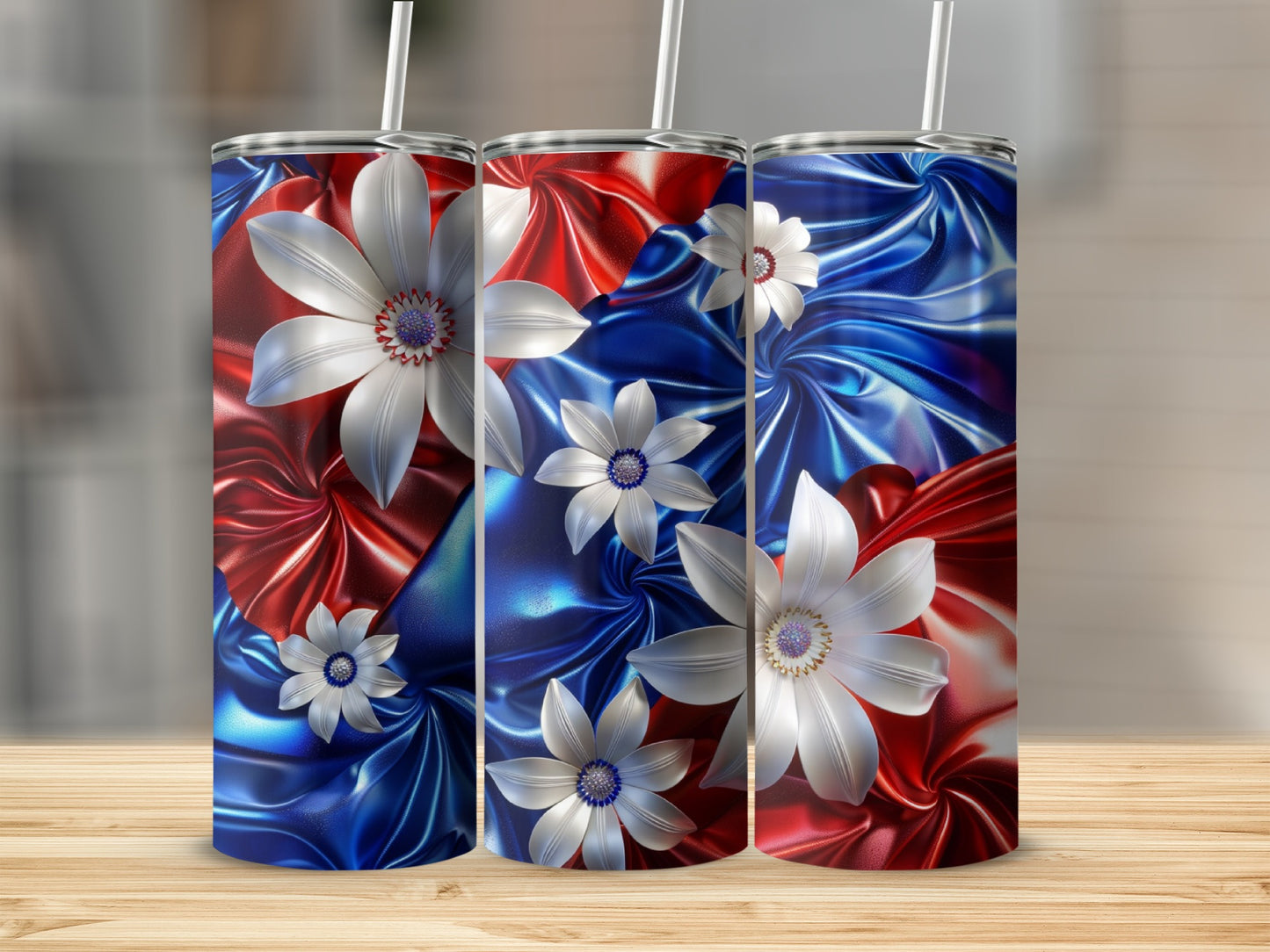 Three tumblers with patriotic red, white, and blue floral designs.