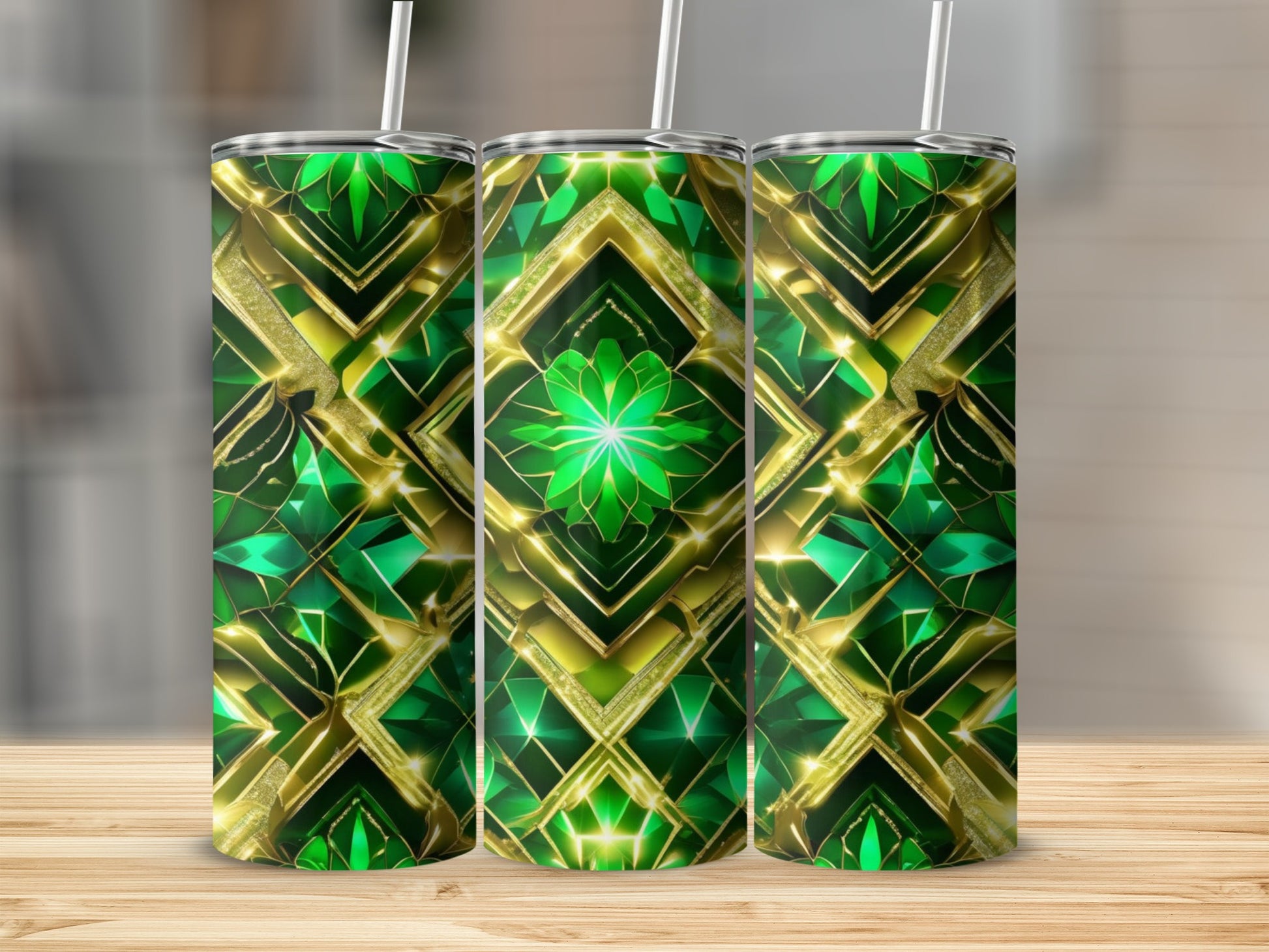 Three green and gold geometric patterned tumblers on a wooden surface.