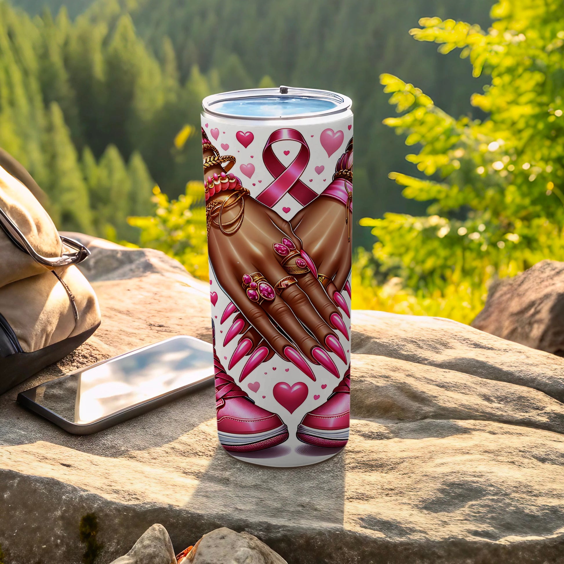 Tumbler with pink ribbon, hearts, and manicured hands with pink nails.