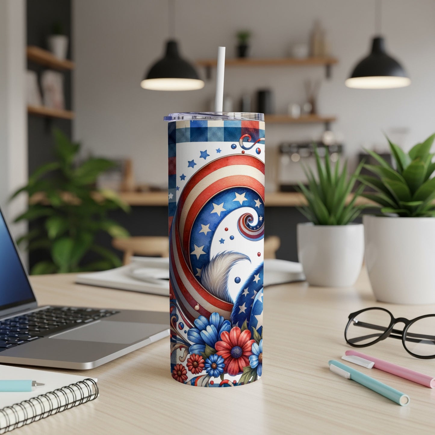 Patriotic tumbler with stars, stripes, and floral designs.