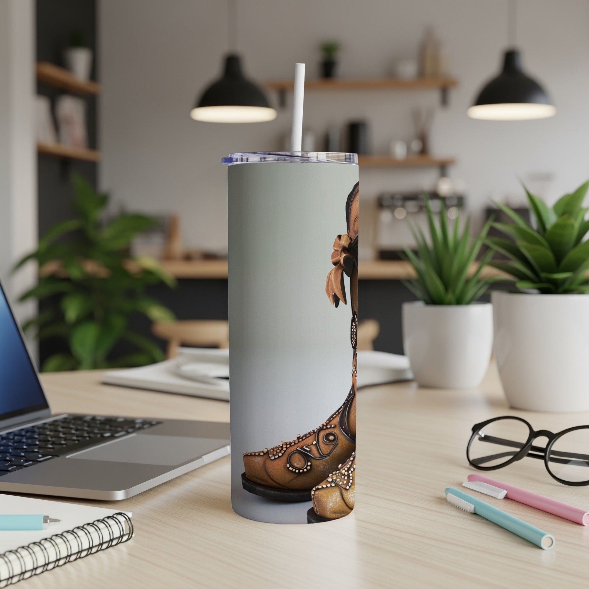 Brown leather cowboy boot tumbler with ornate beadwork and a straw.
