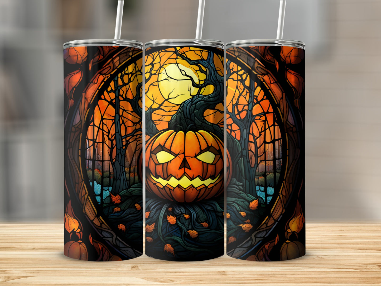 Halloween jack-o'-lantern with spooky forest background on three tumblers.