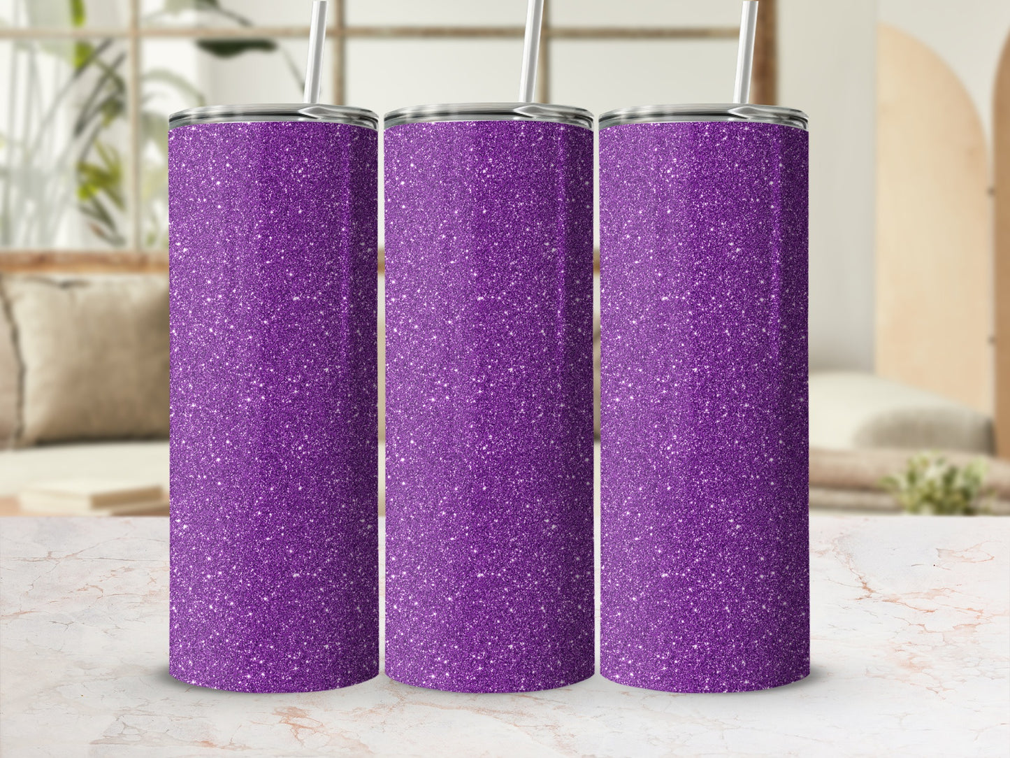 Three glittery purple tumblers with straws in a studio setting.