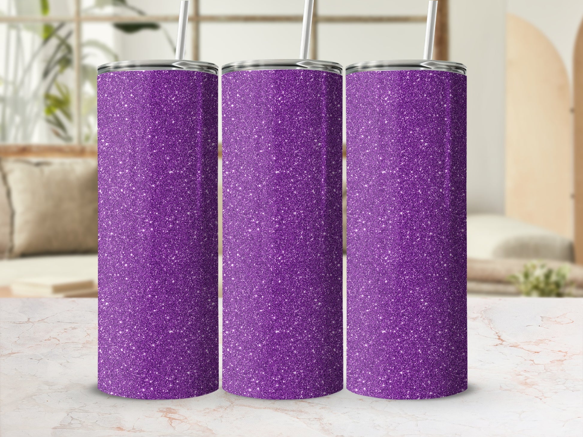 Three glittery purple tumblers with straws in a studio setting.