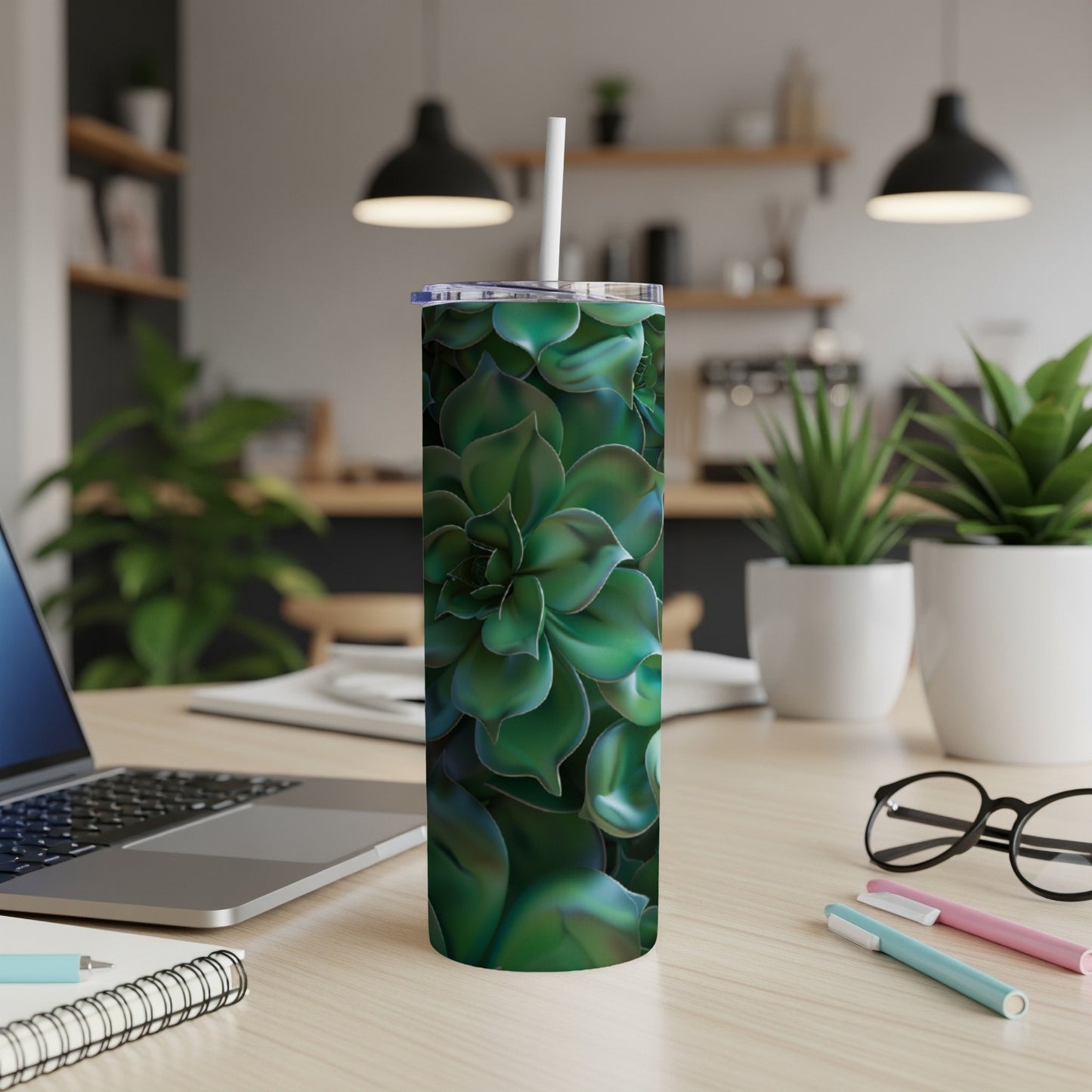 Green succulent pattern on a white insulated tumbler with straw.