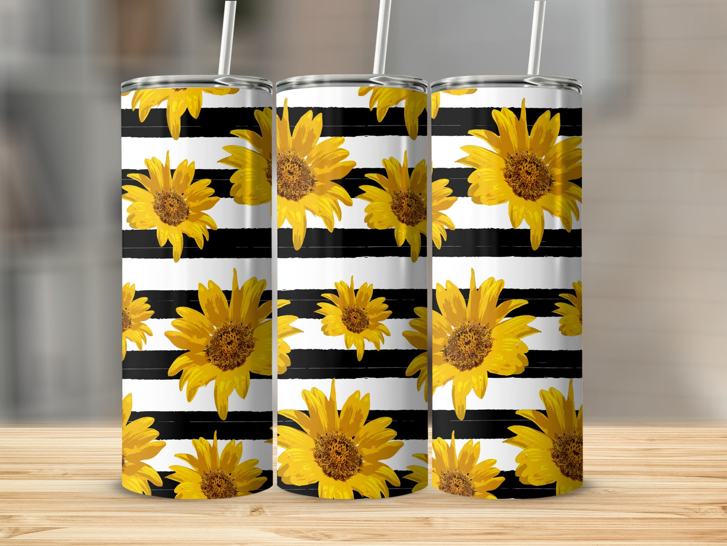 Three tumblers with black and white stripes and a sunflower pattern.