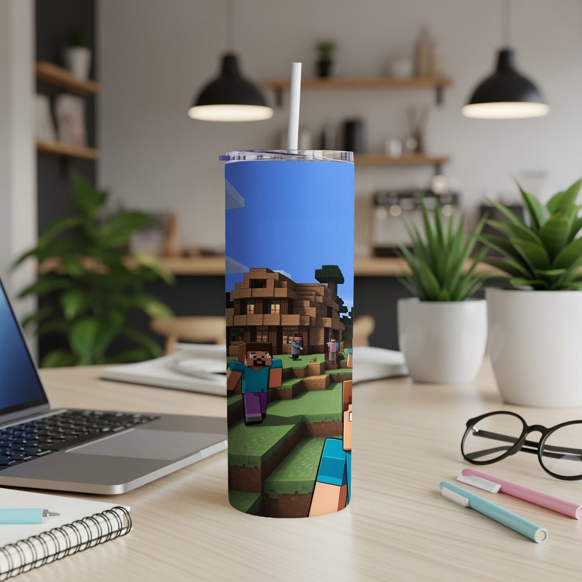 Minecraft-themed tumbler with characters and buildings on a desk.