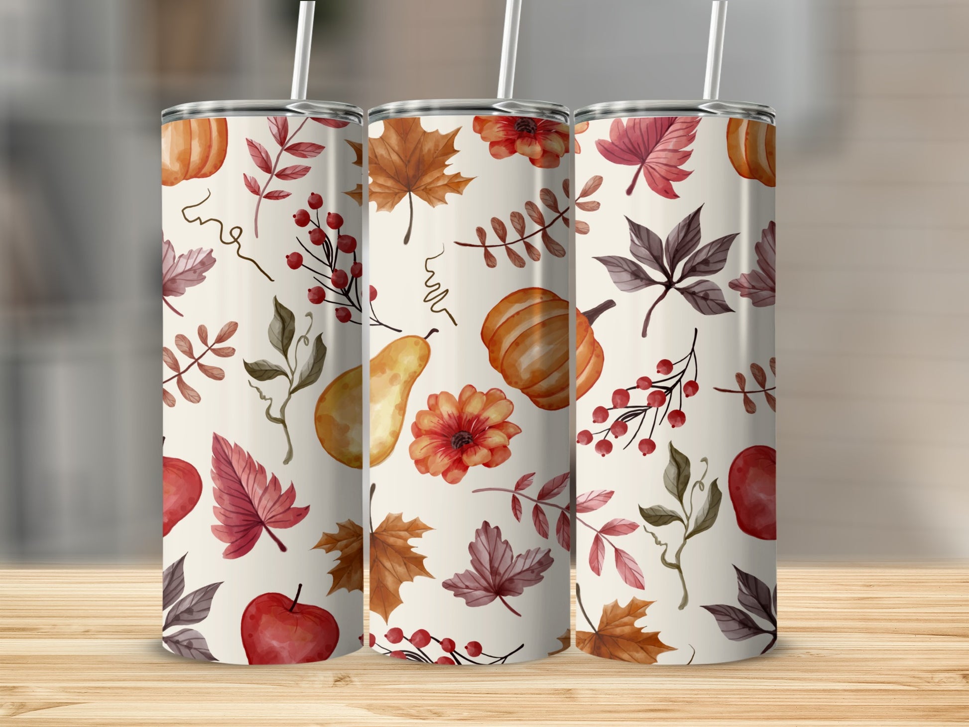 Three tumblers with autumn leaf and pumpkin pattern.