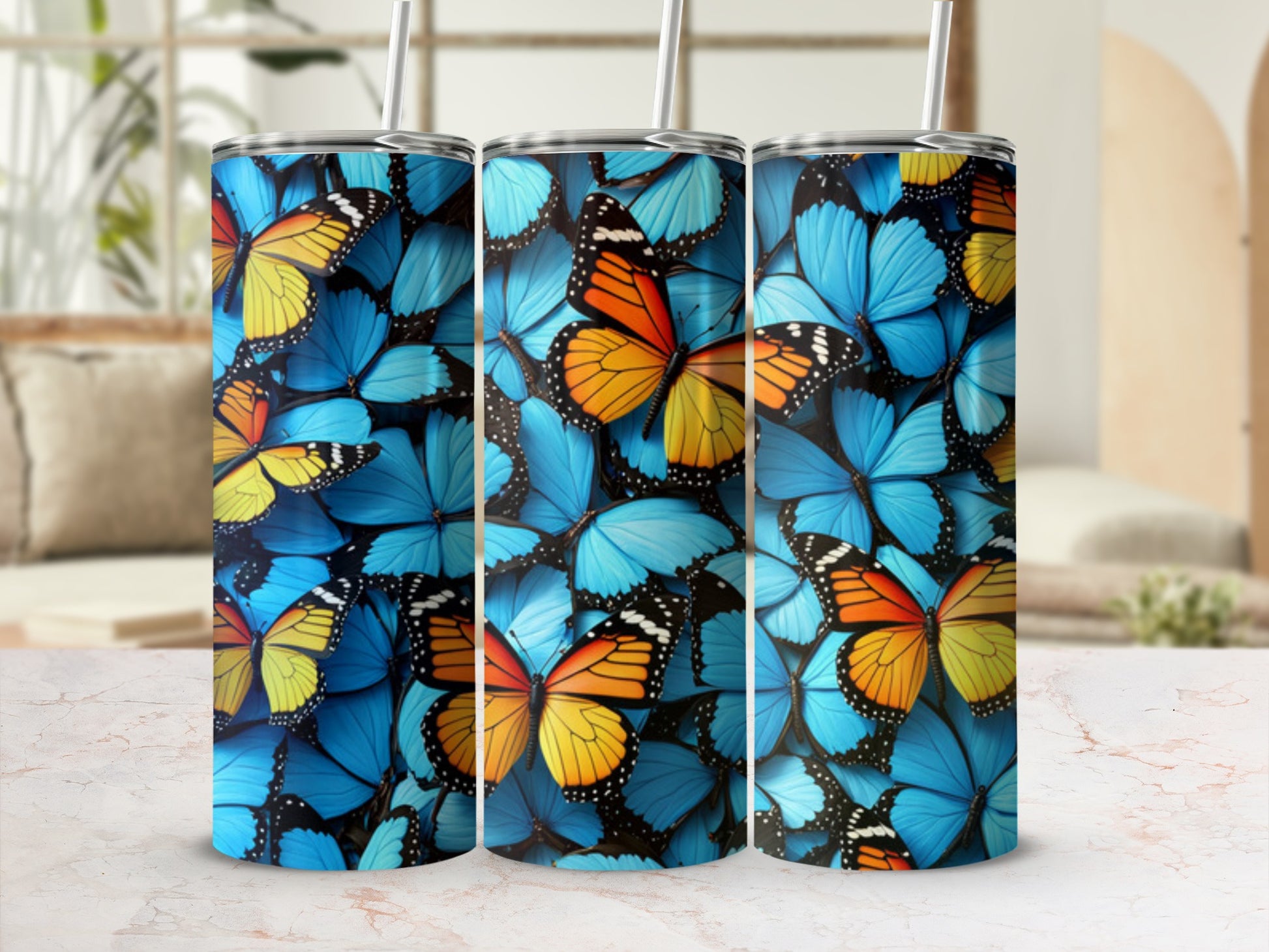 Three tumblers decorated with blue and orange butterfly patterns.