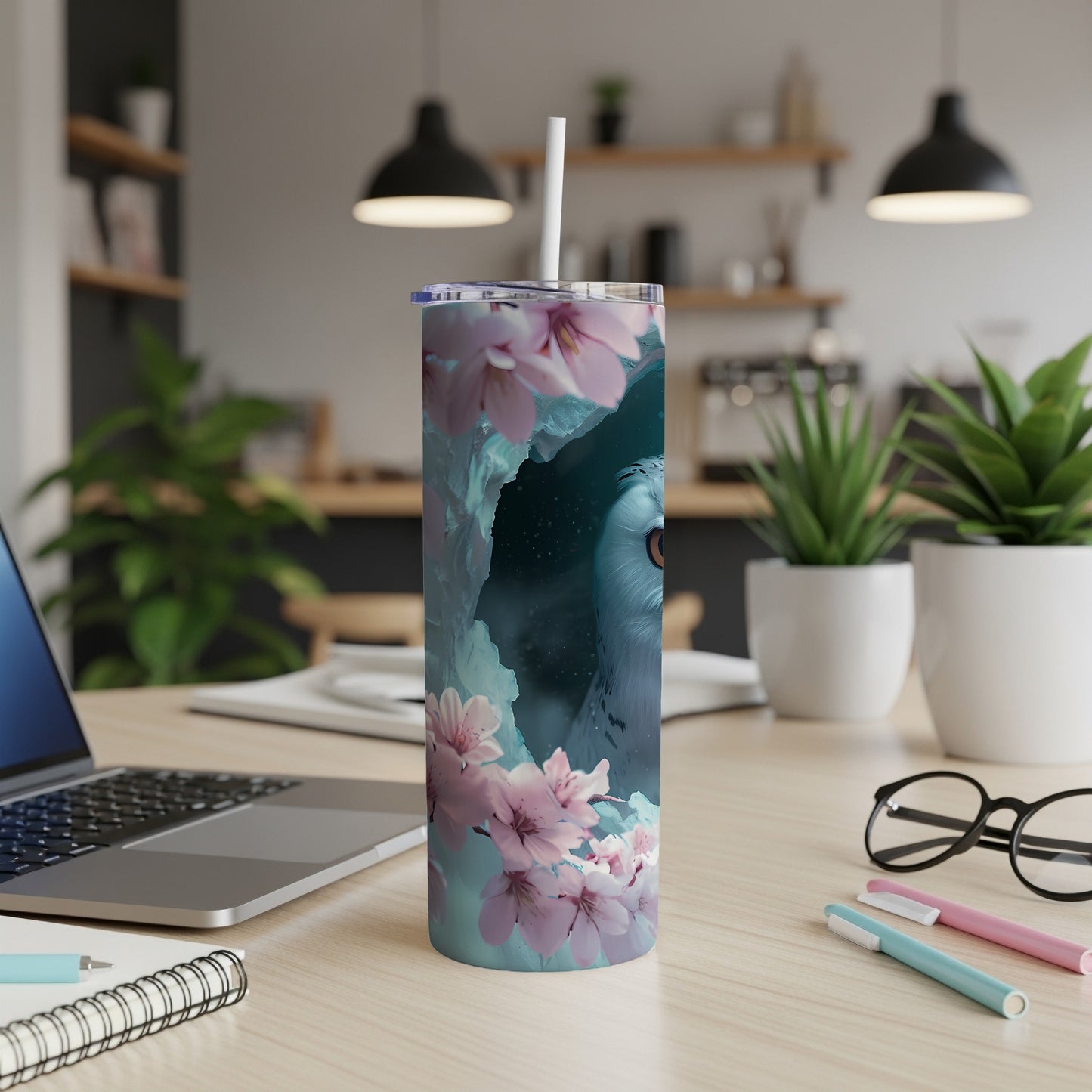 Snowy owl and cherry blossoms on a blue patterned tumbler.