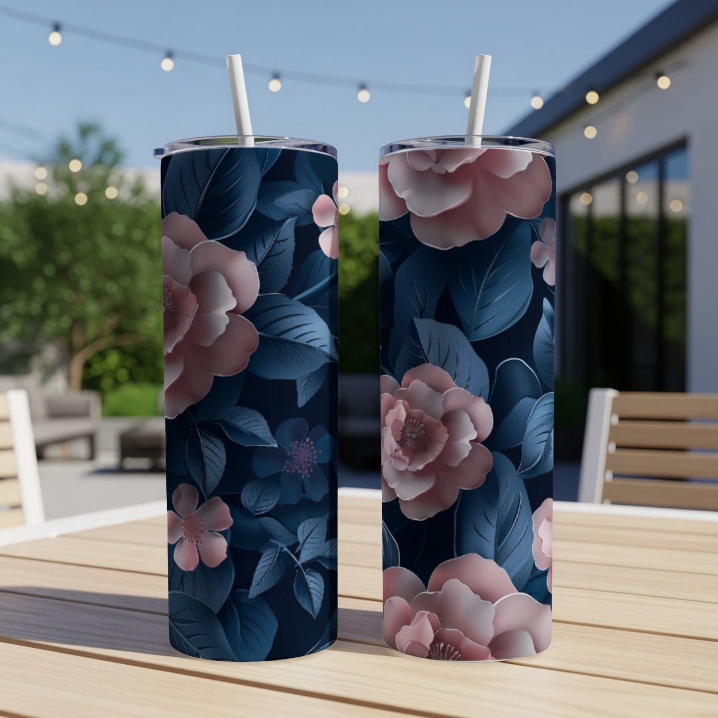 Two tumblers with a pink and blue floral pattern sit on a table.