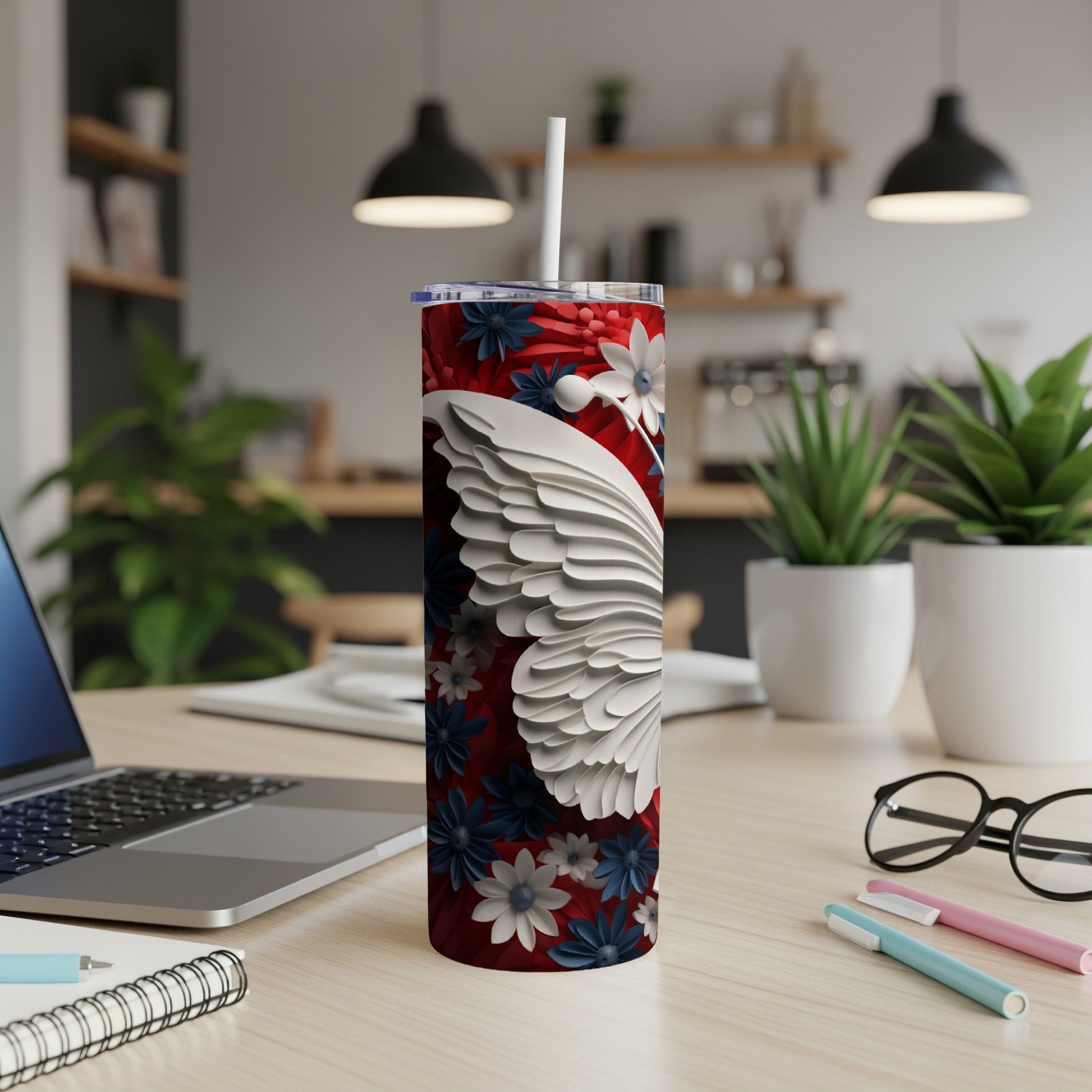 White feathered Santa hat design on a red floral pattern tumbler.