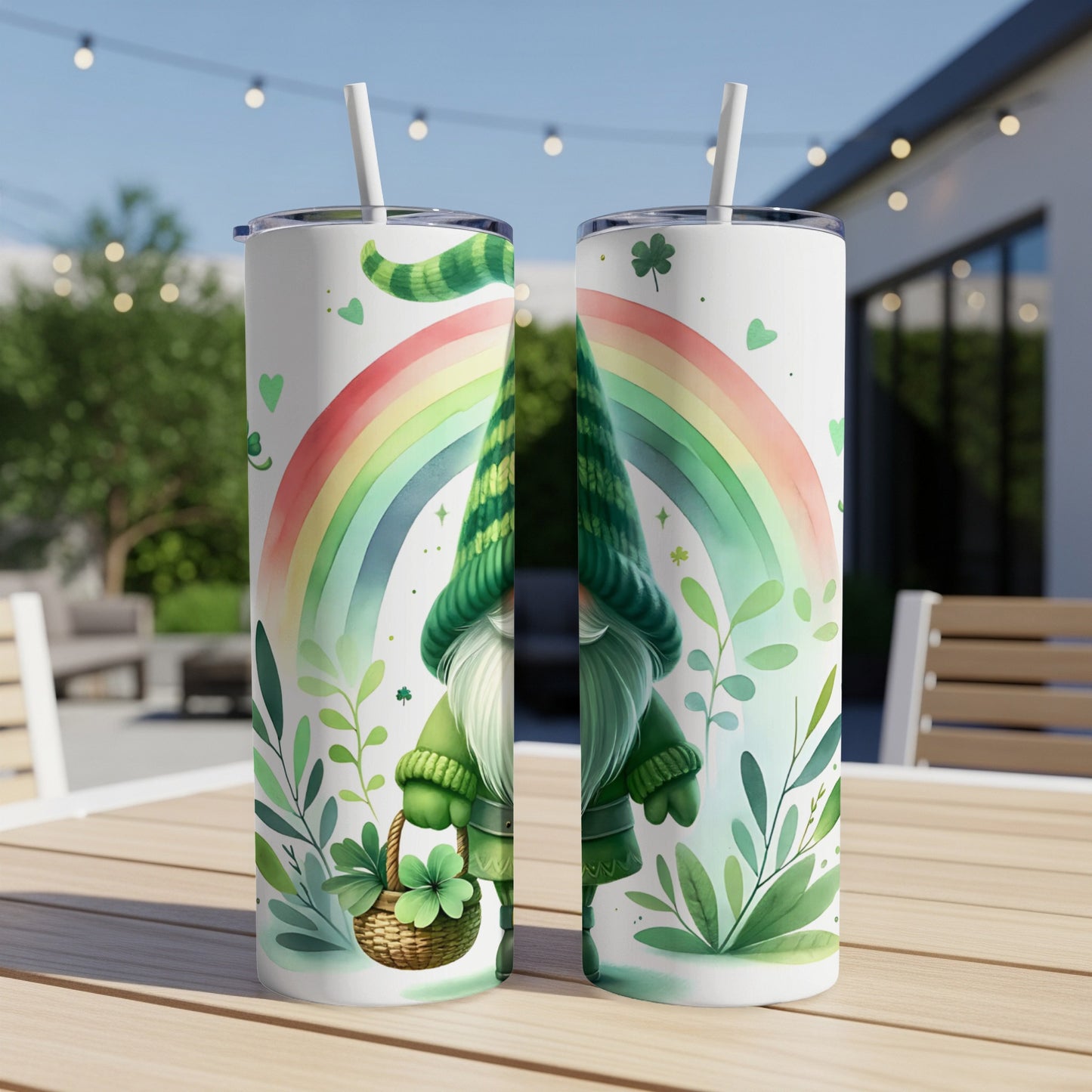 Two tumblers featuring a gnome, rainbow, and shamrocks on a table.