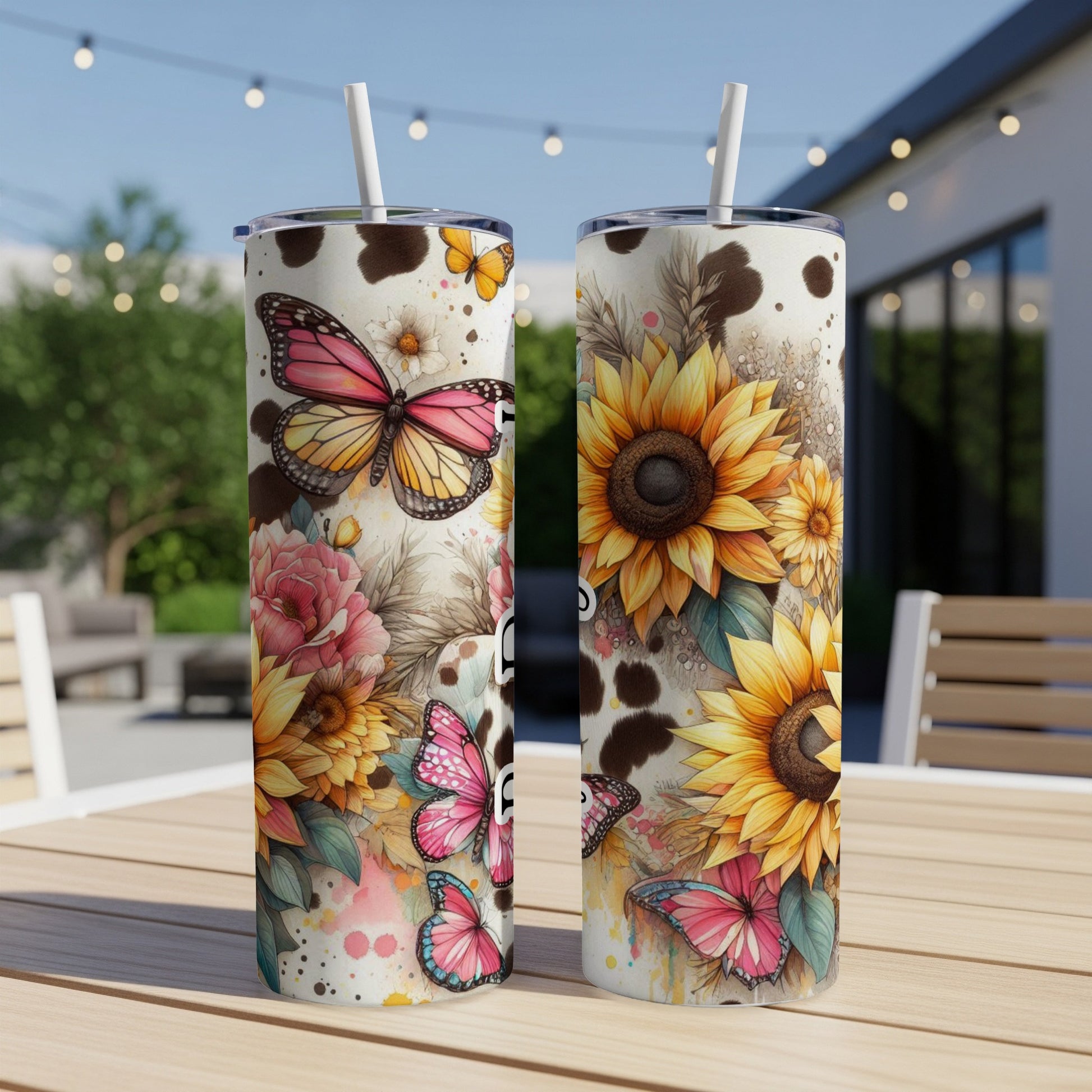 Two tall tumblers with sunflowers, butterflies, and cow print pattern.