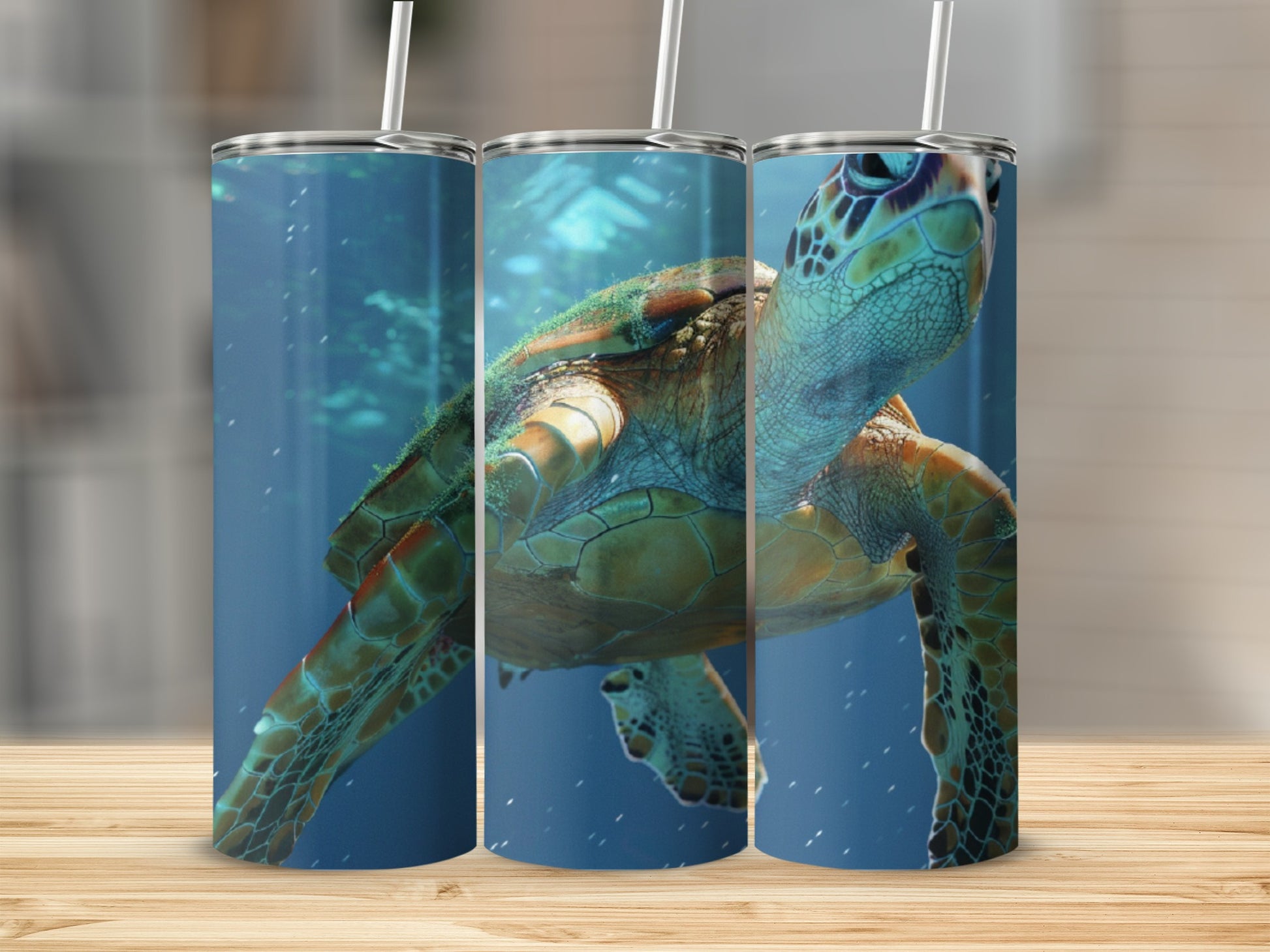 Three tumblers with a sea turtle swimming underwater, presented on a wooden surface.