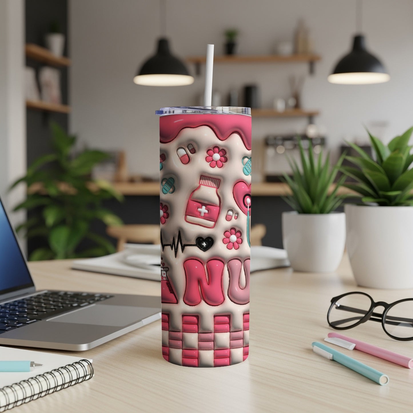Pink tumbler with medical icons and "RN" text on a desk.
