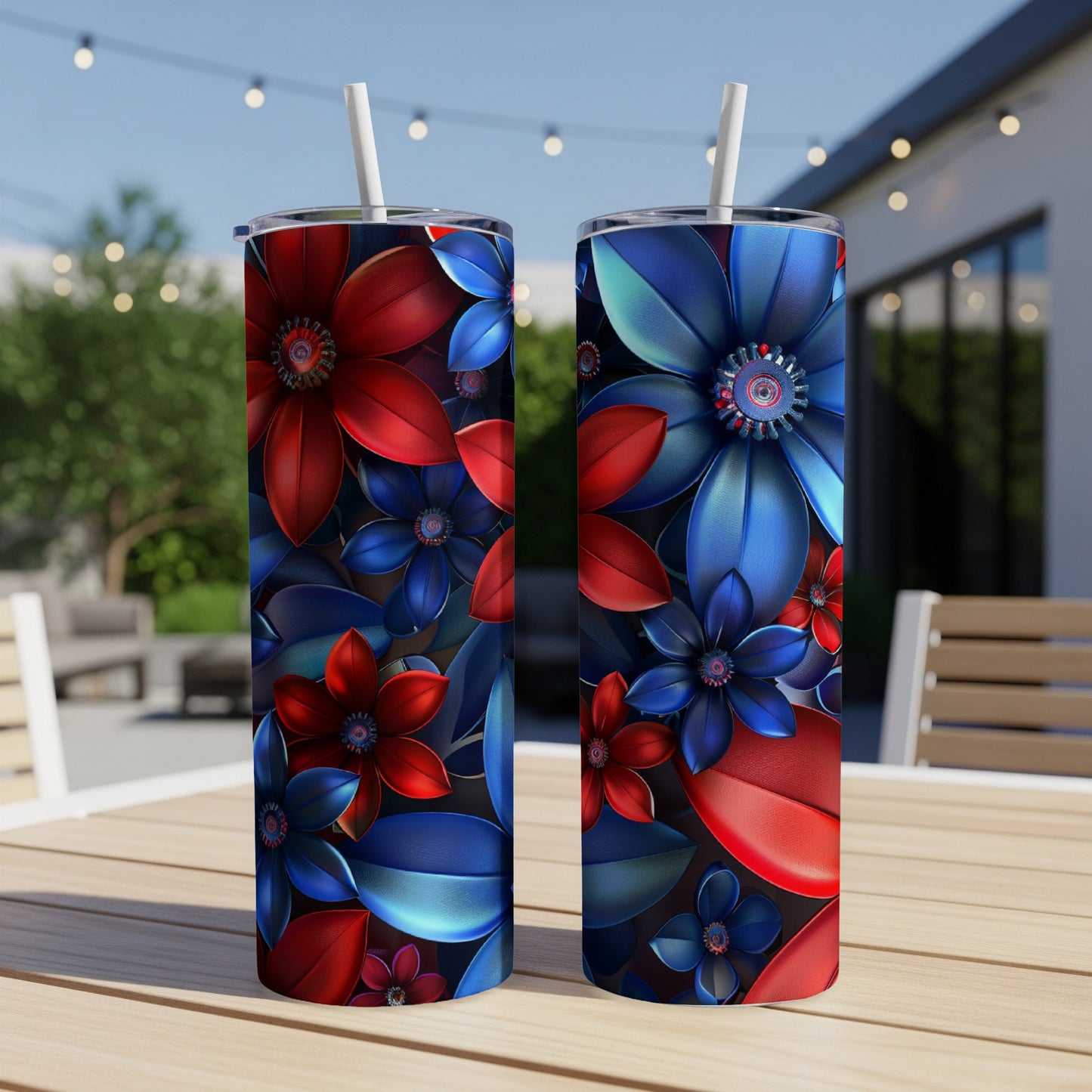 Two tall tumblers with red and blue floral designs on a table.