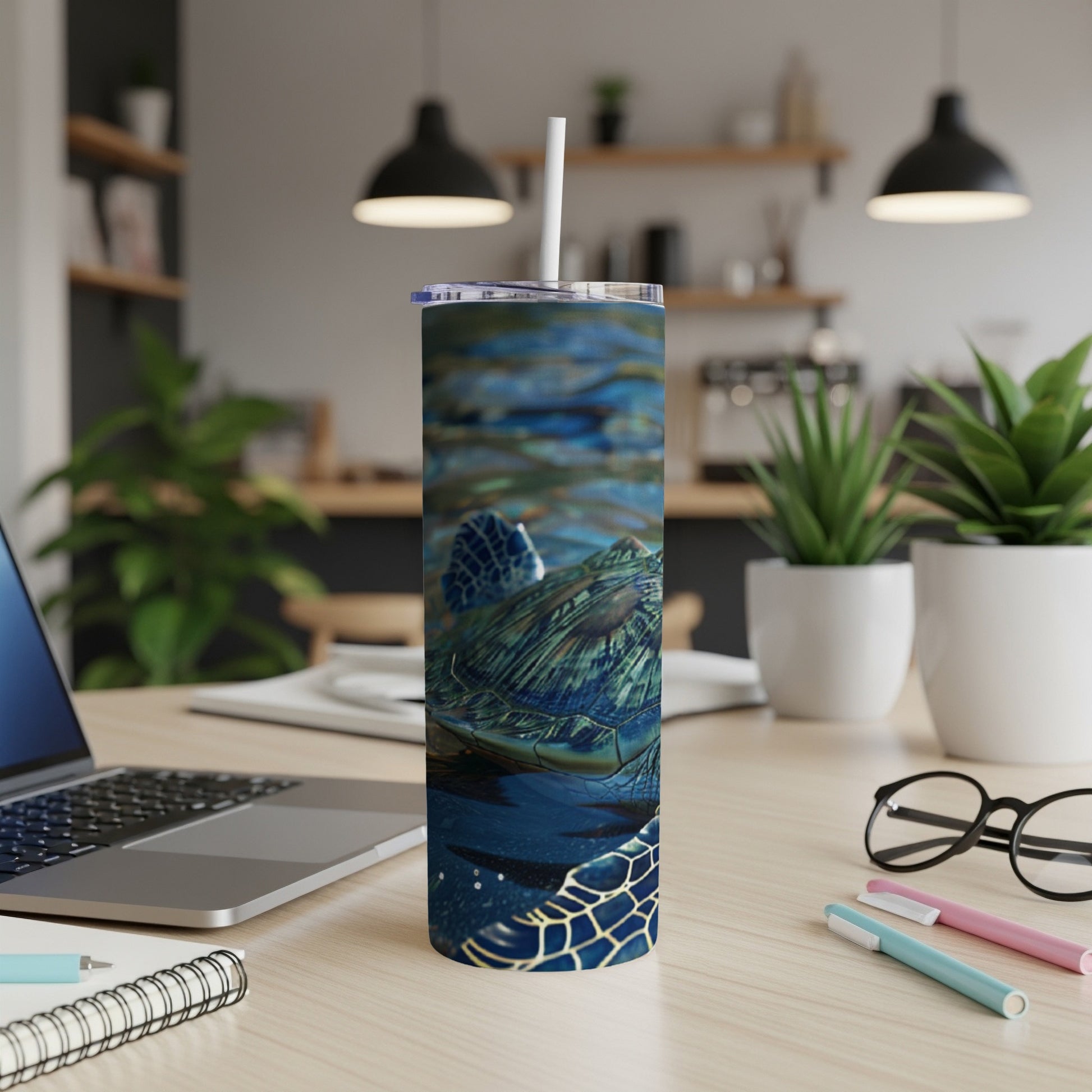 Sea turtle in blue water on a skinny tumbler with a straw.