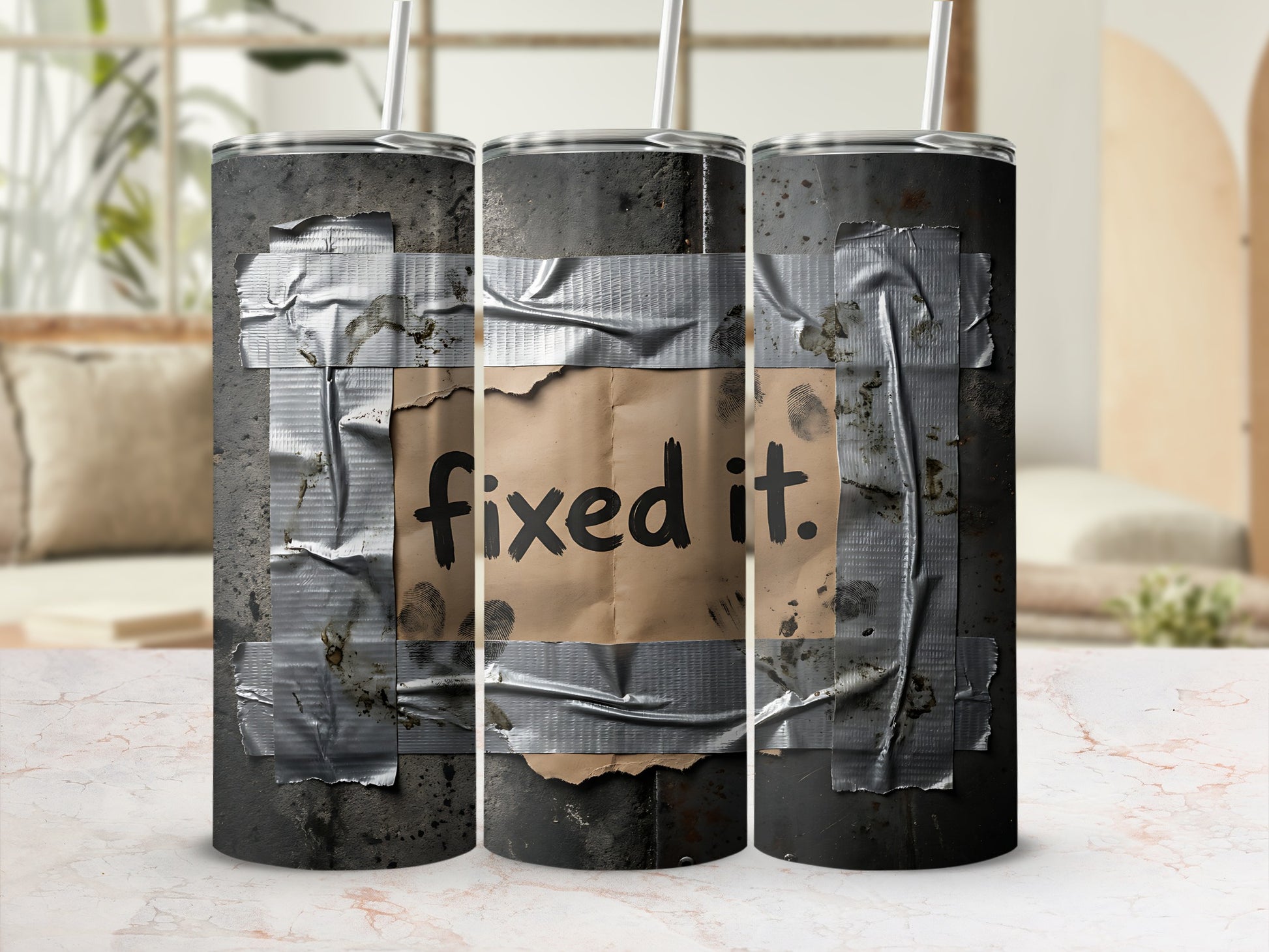 Taped tumbler with "Fixed it." text in black marker on a tan paper patch.