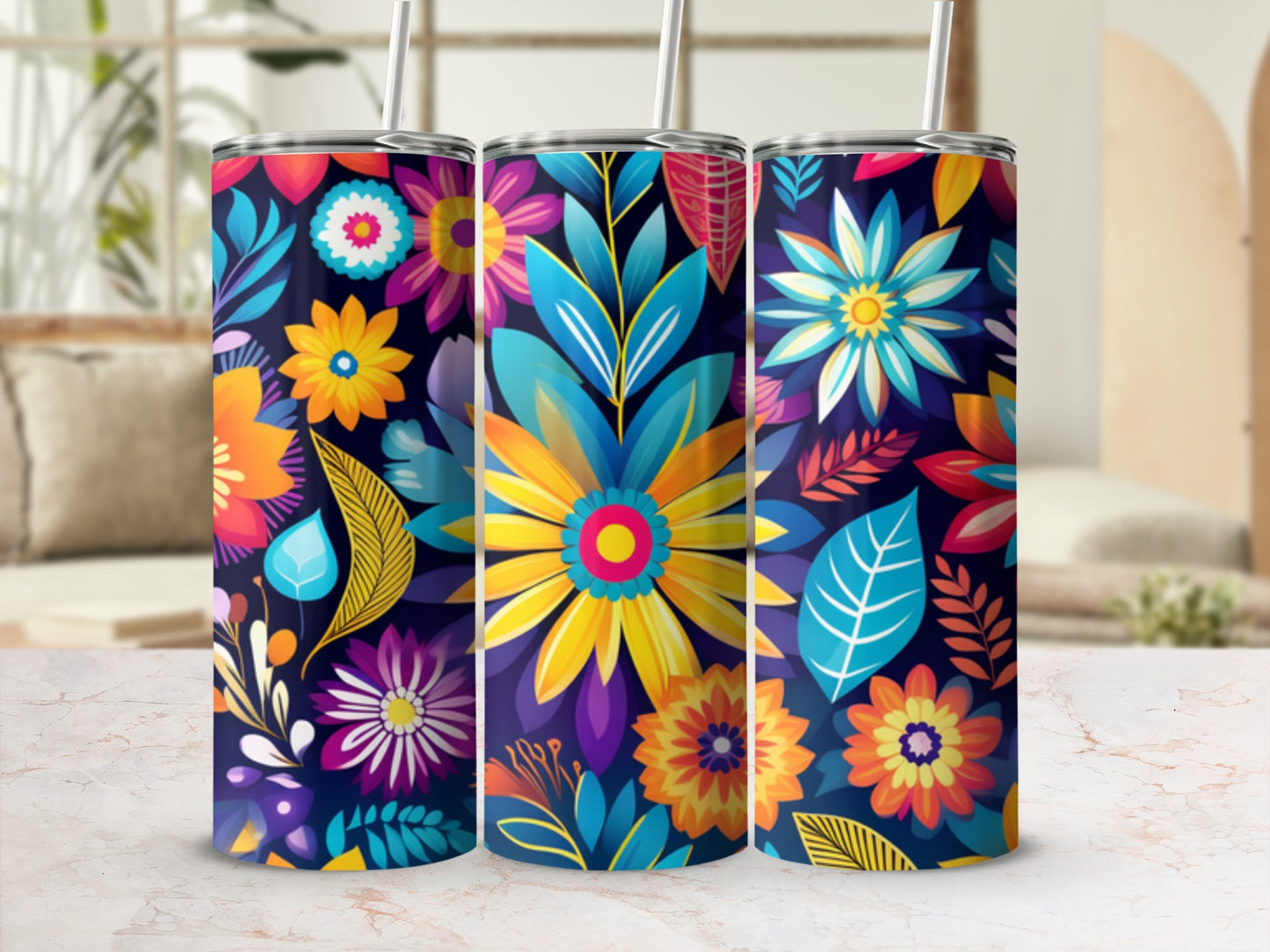 Colorful floral pattern on three tall tumblers with straws.