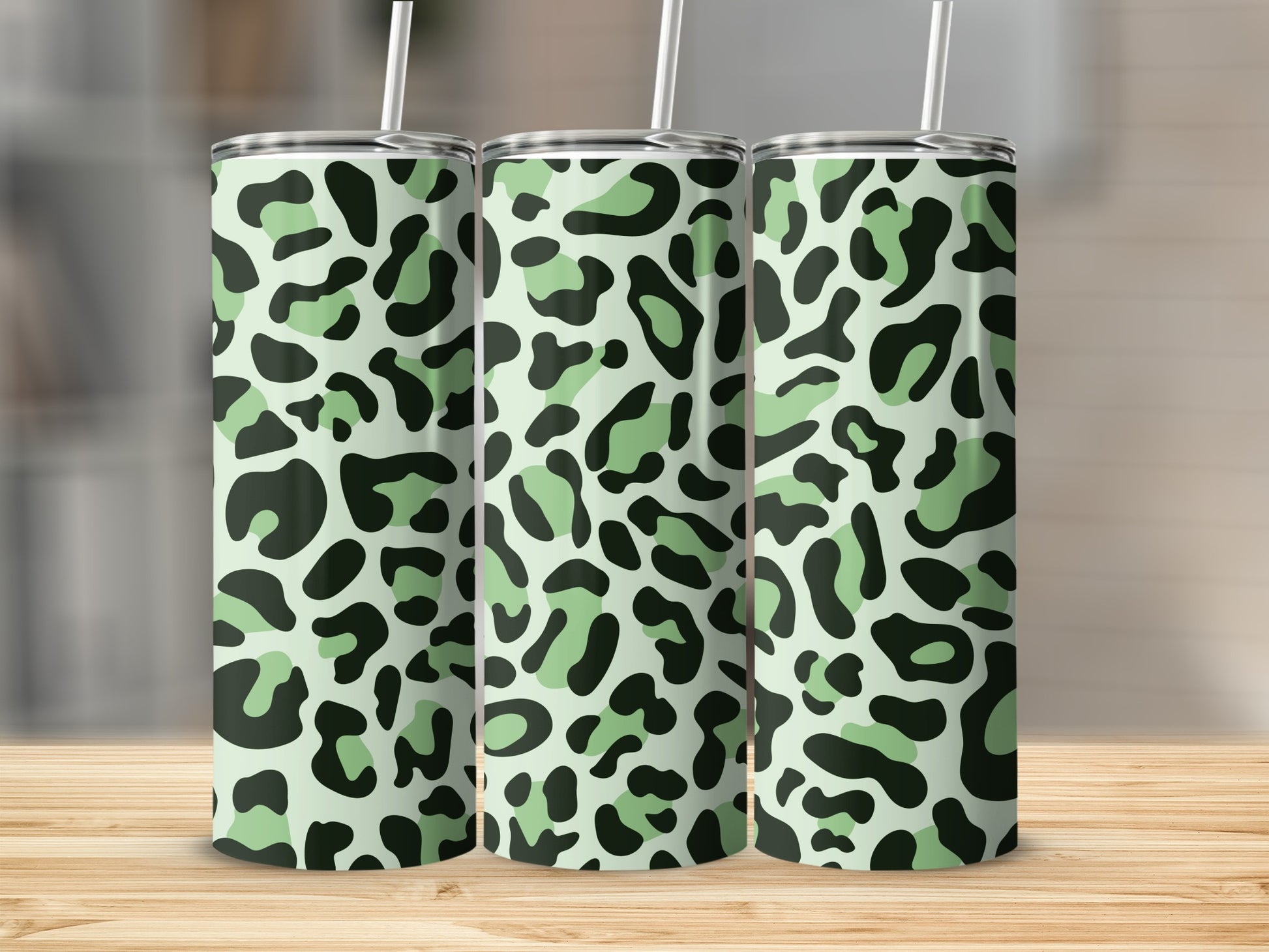 Three tumblers with a light green and black leopard print pattern.