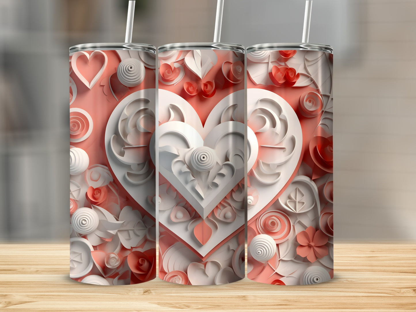 Three tall tumblers with white and pink heart and floral layered designs.