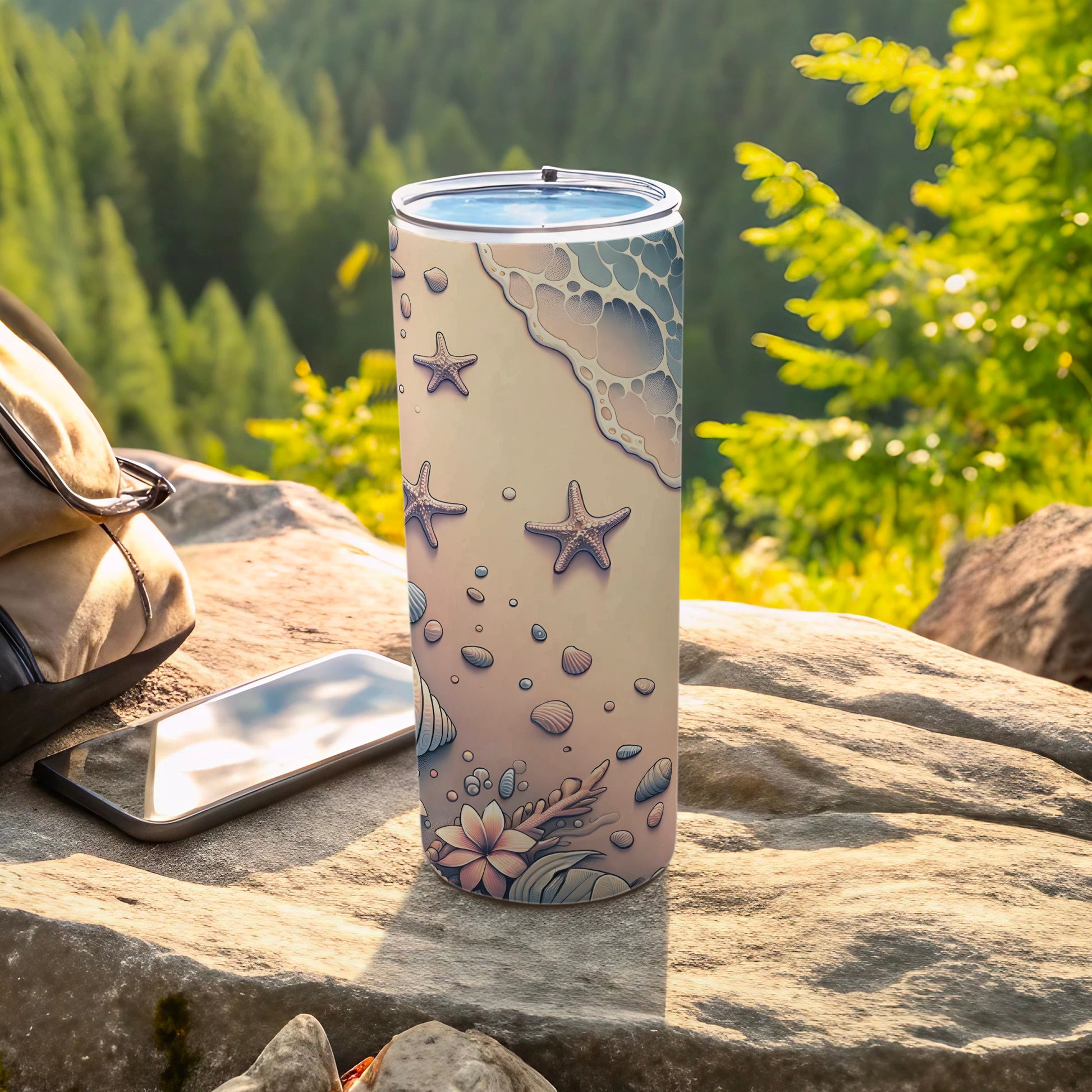 Ocean-themed tumbler with starfish, shells, and flowers on a rocky, outdoor surface.