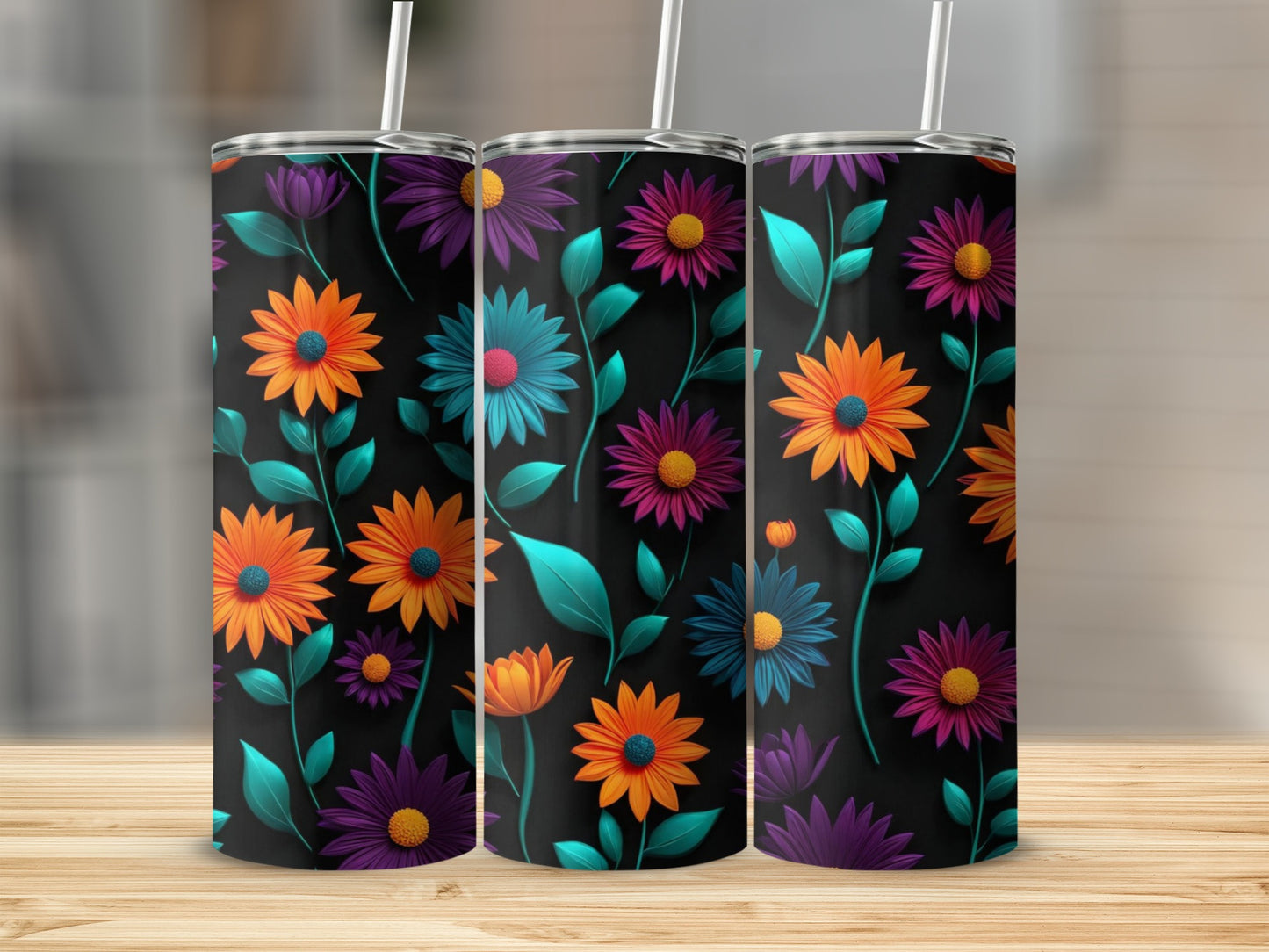 Three tumblers with a floral pattern featuring orange, purple, and teal flowers.