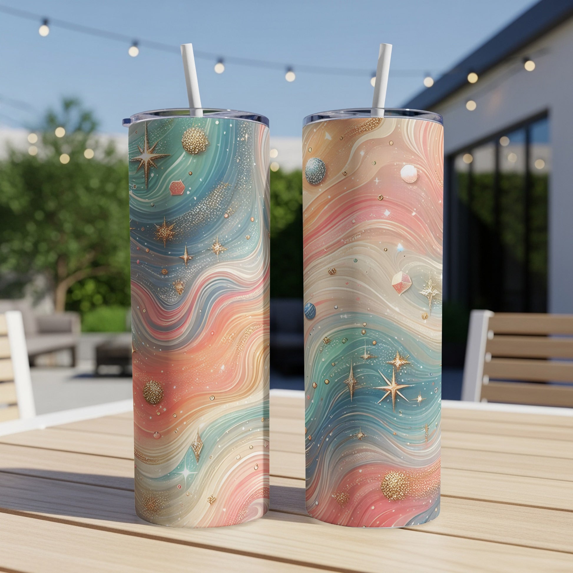 Two colorful tumblers with celestial star and planet patterns.