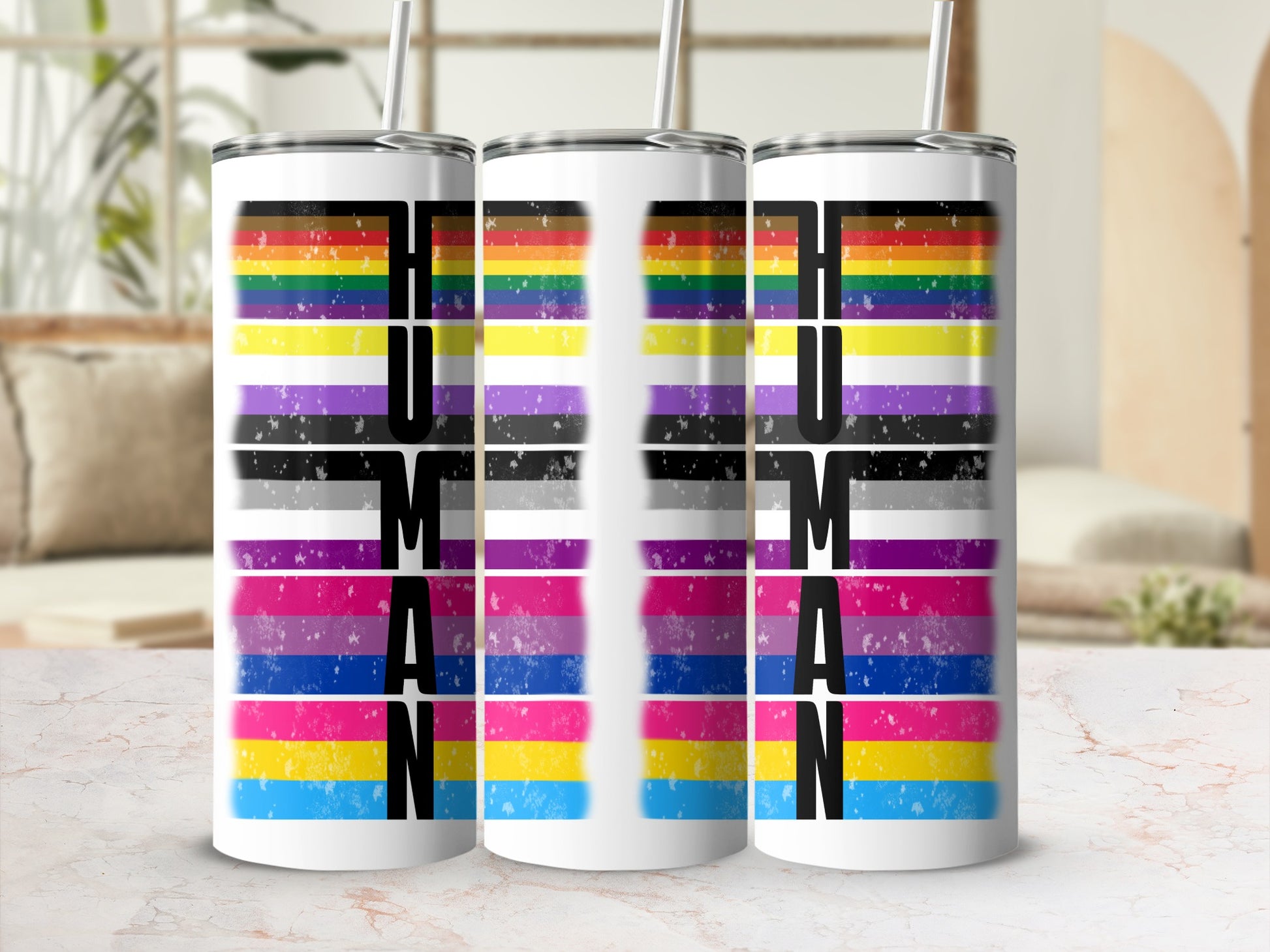 Three tumblers with "HUMAN" text and LGBTQ+ pride flags.