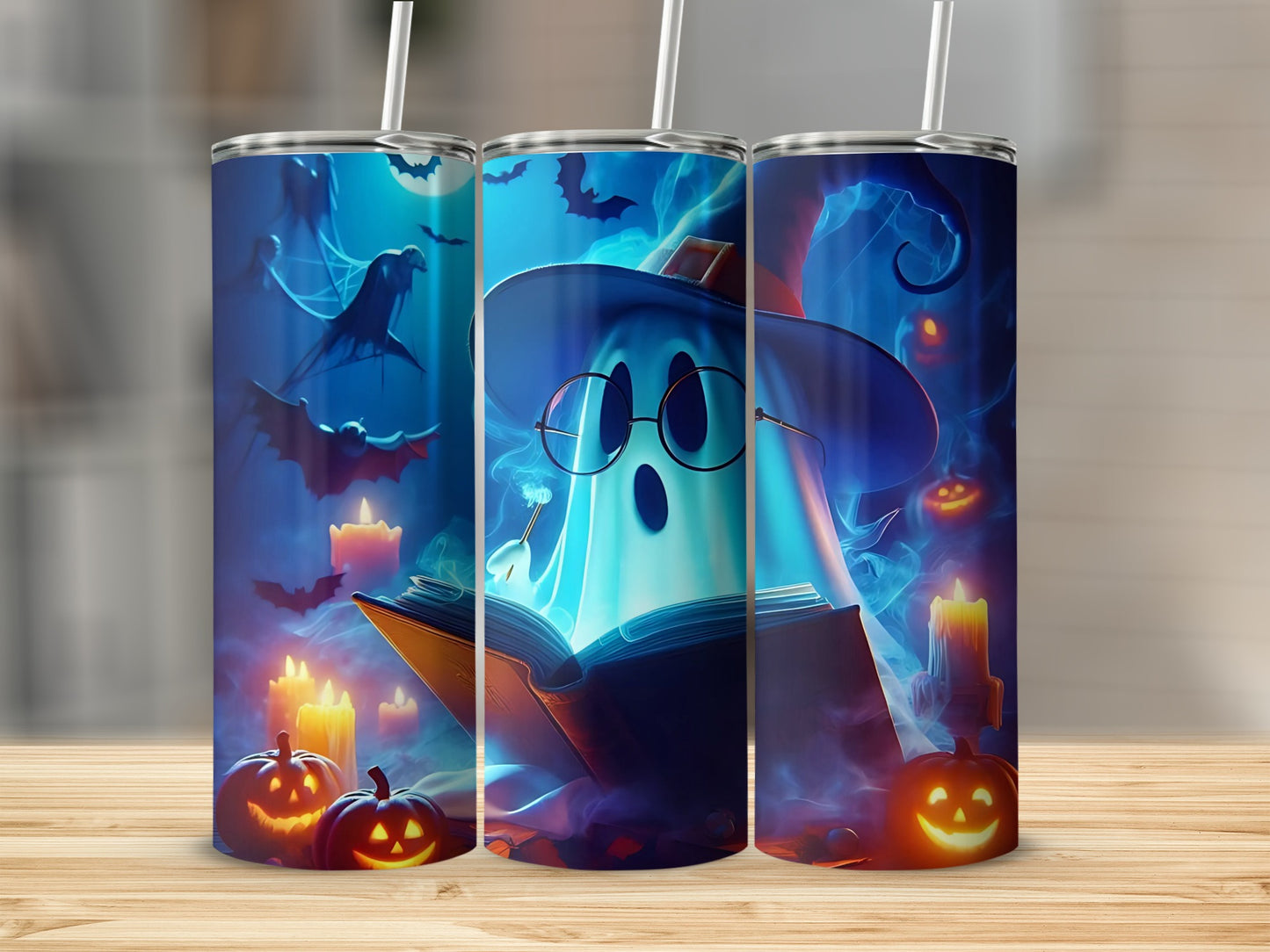 Halloween tumblers with ghosts, pumpkins, bats, and candles on a blue background.