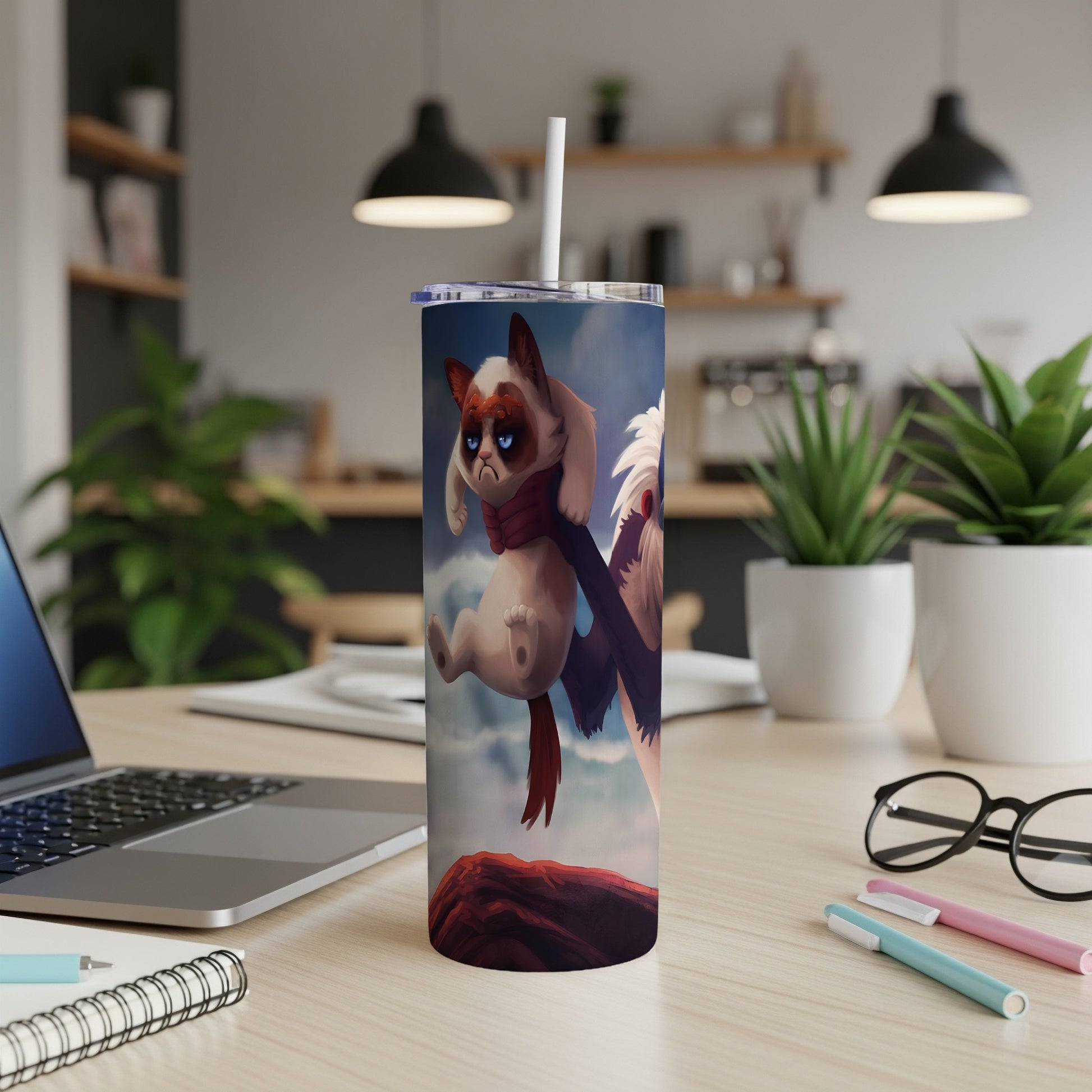 Grumpy cat design on a white tumbler with a straw, on a desk.