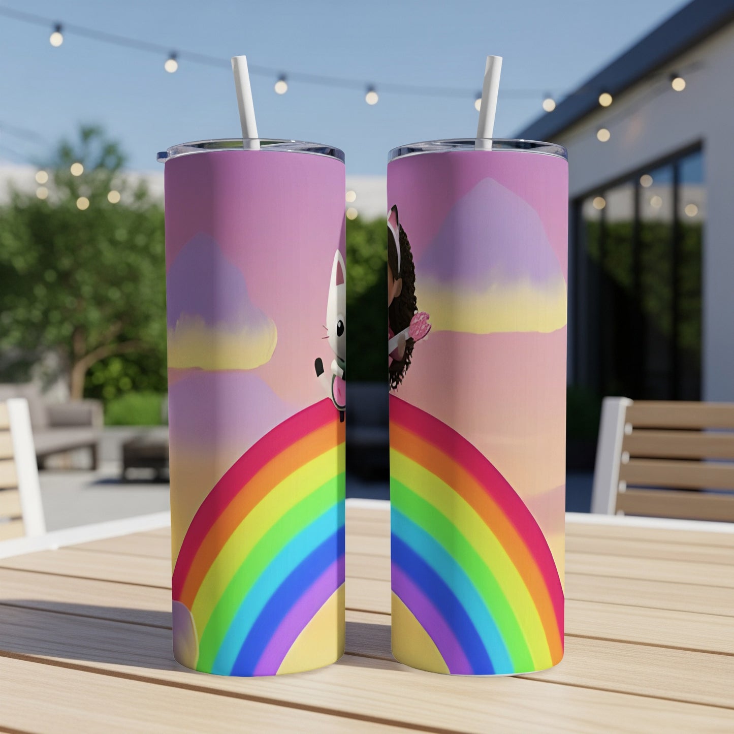 Two stainless steel tumblers featuring a cartoon cat on a rainbow against a colorful sky.