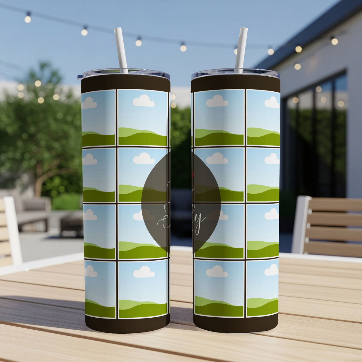 Two tumblers with landscape grid designs sit on a wooden table.