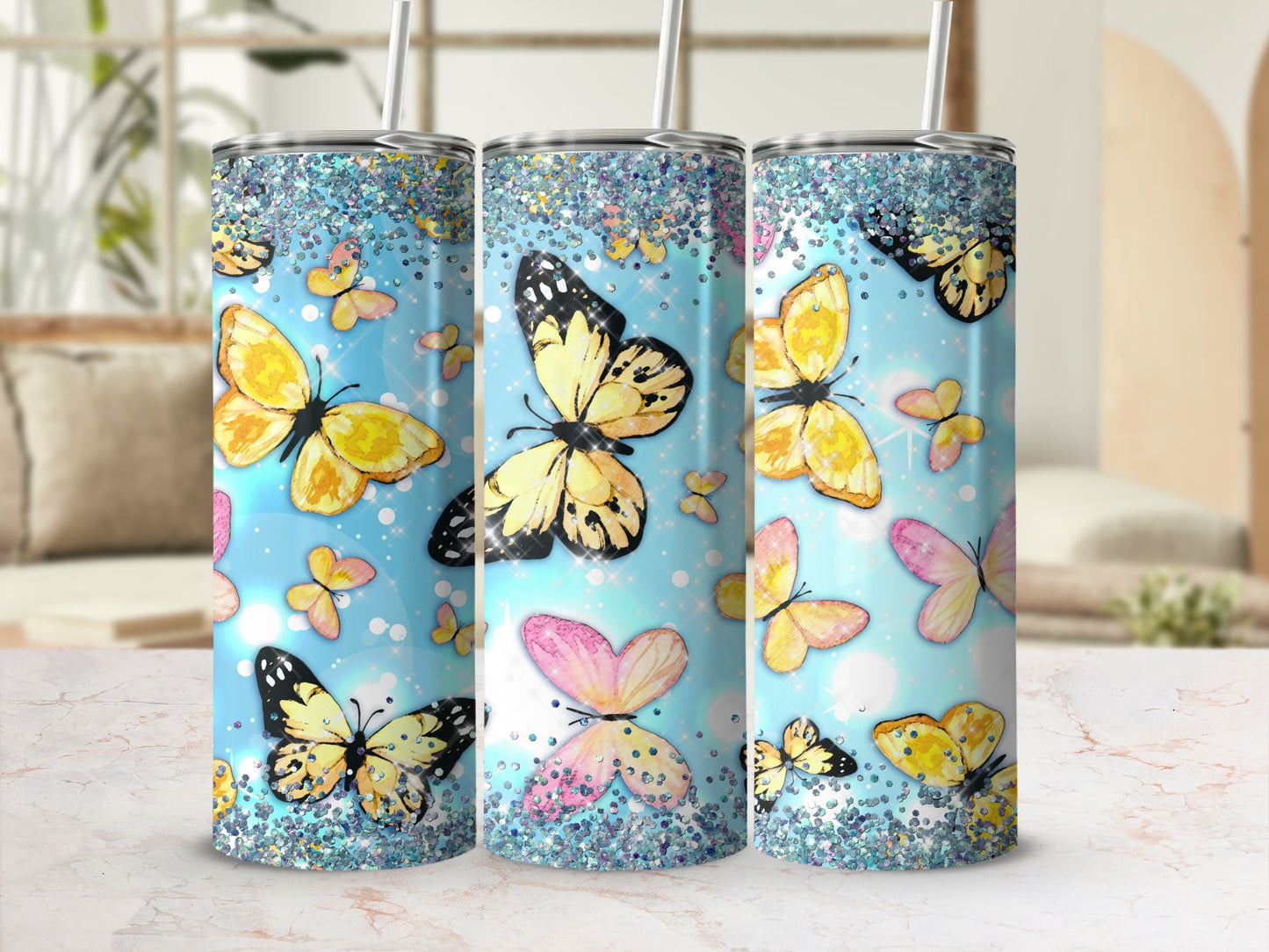 Three tumblers with glittery tops and butterfly designs in light blue.