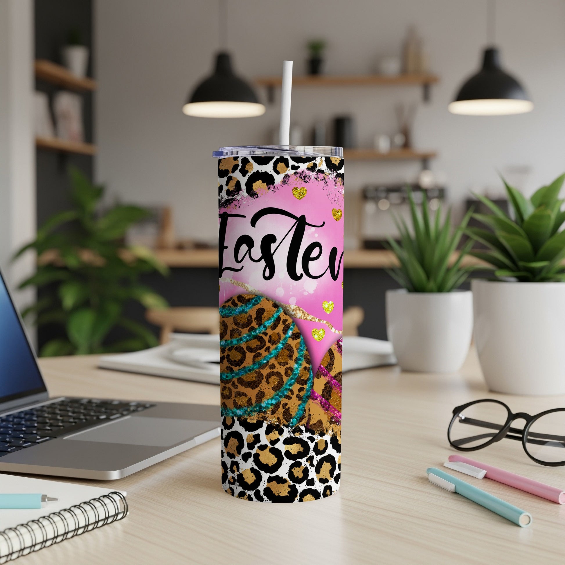 Leopard print tumbler with pink glitter, Easter eggs, and straw.