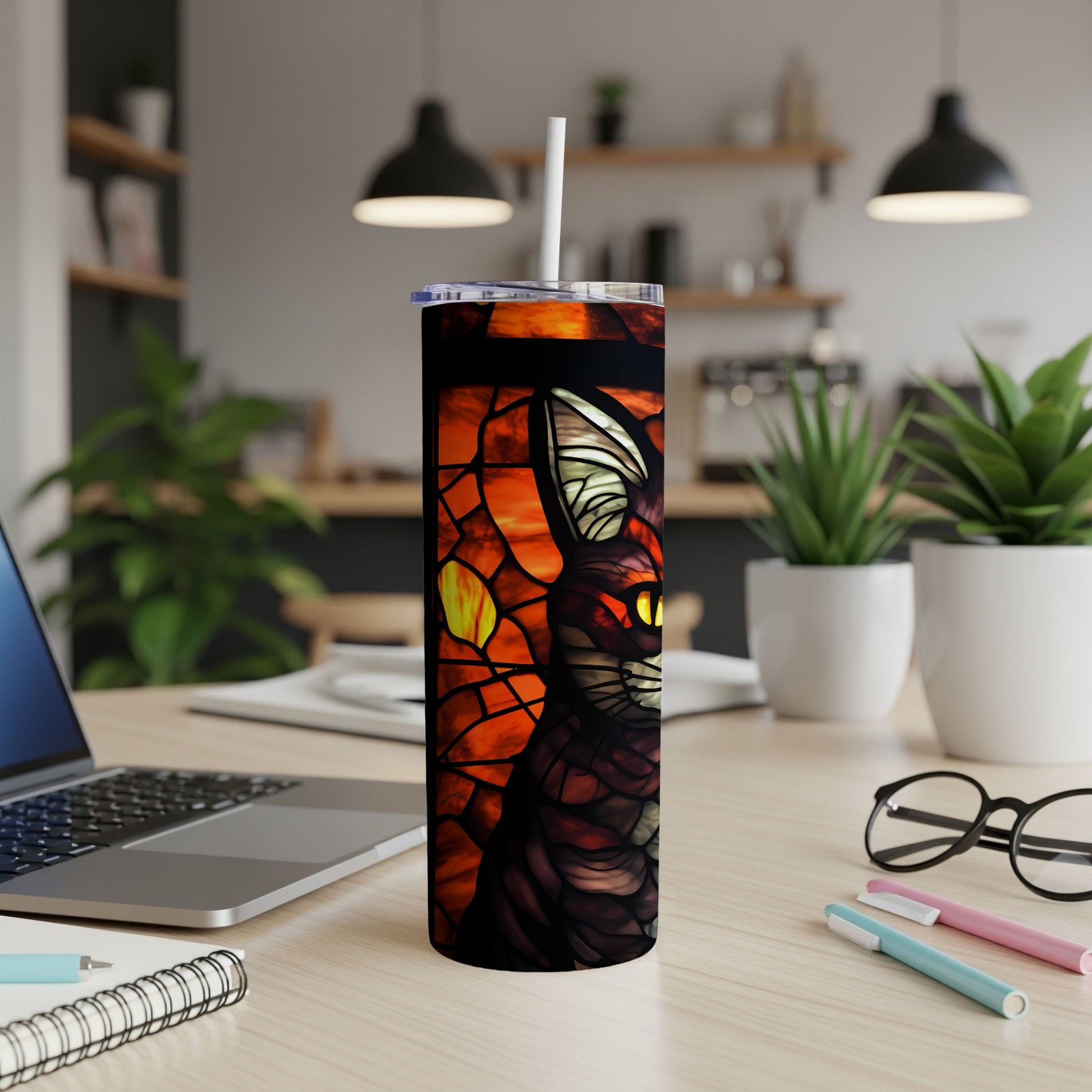 Stained glass cat design on a black tumbler with a straw.