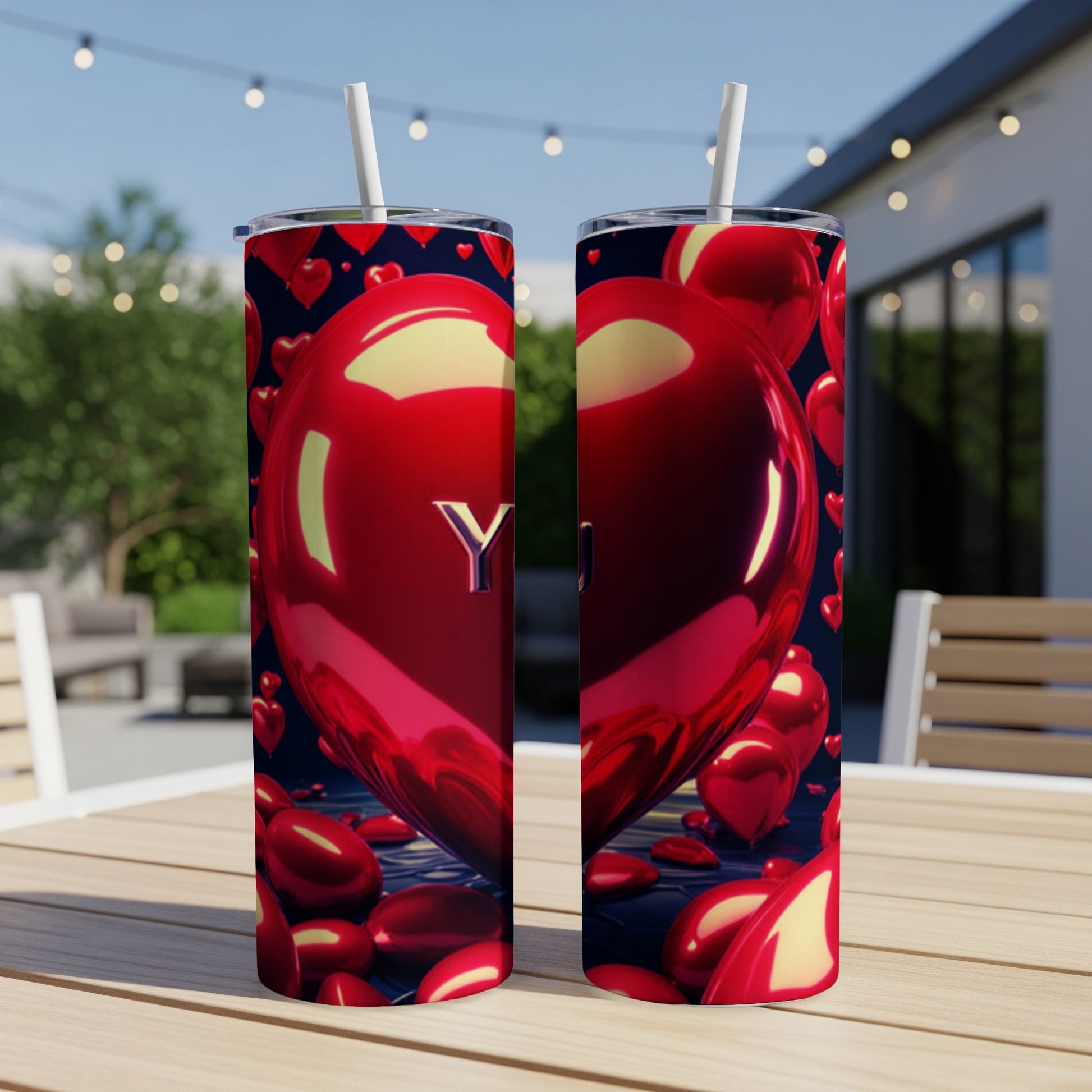 Red heart balloon tumbler with "Y" and "U" text, on a table.
