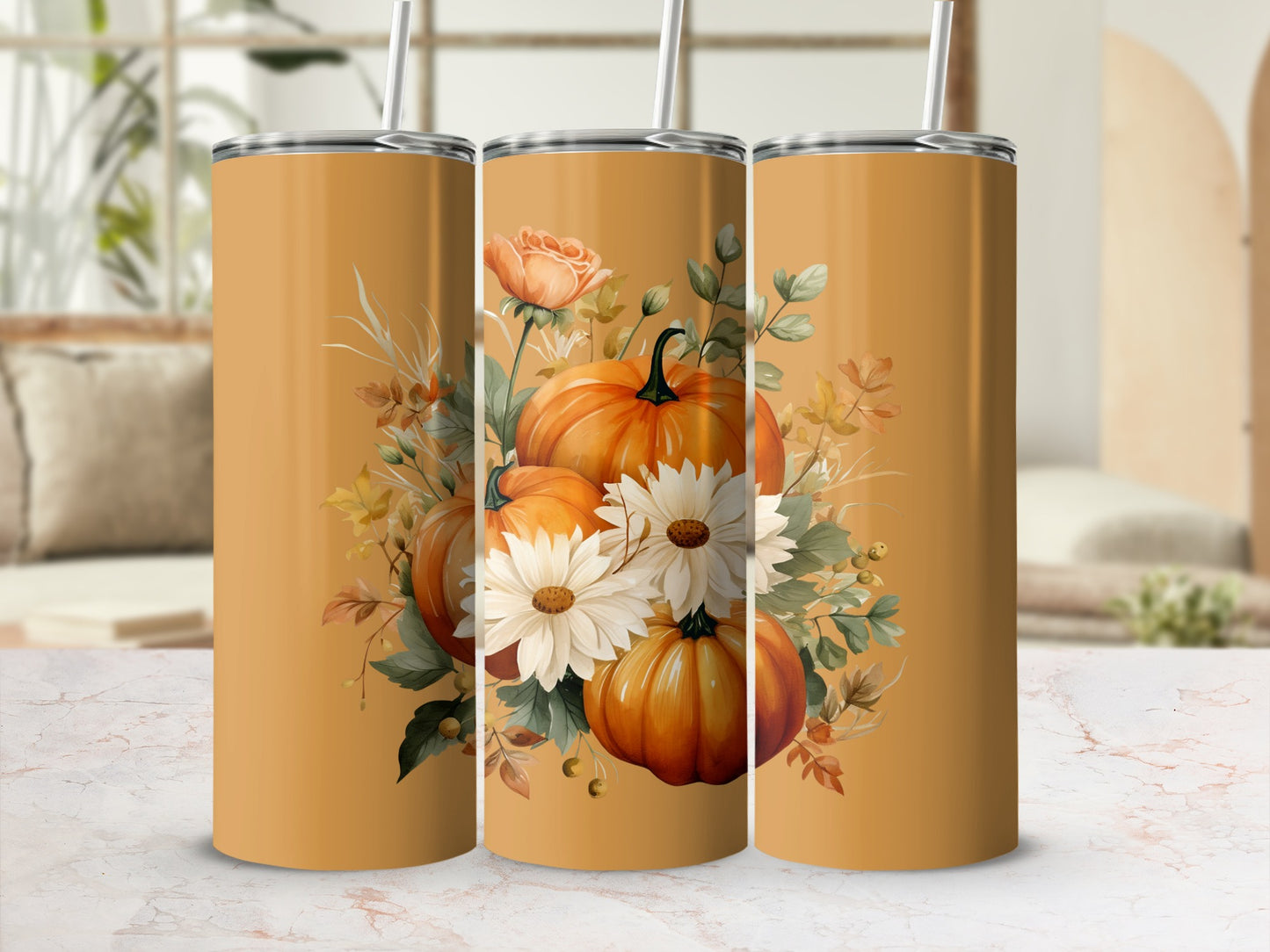 Three orange tumblers with a pumpkin and floral design.