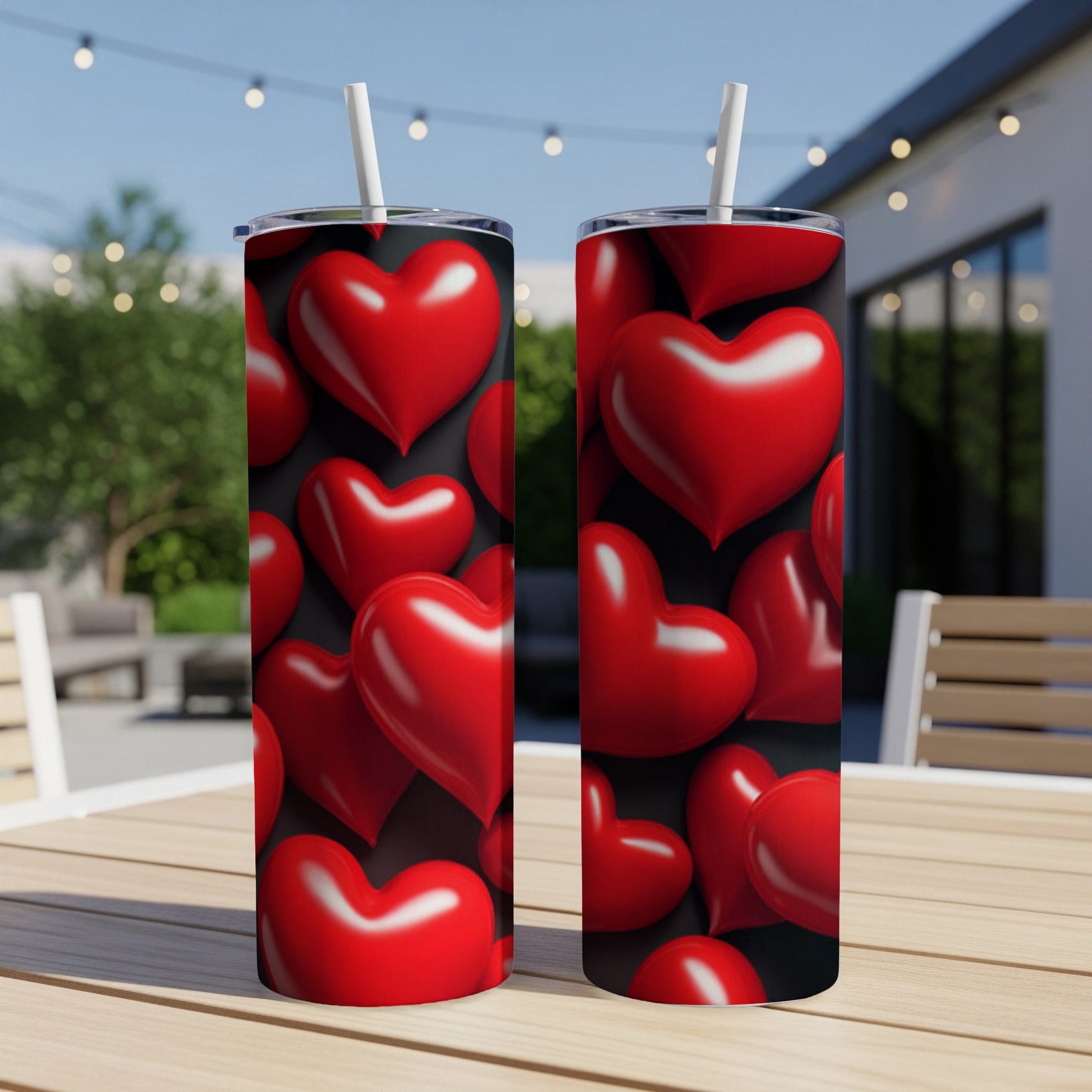Two black tumblers with a repeating pattern of shiny red hearts.